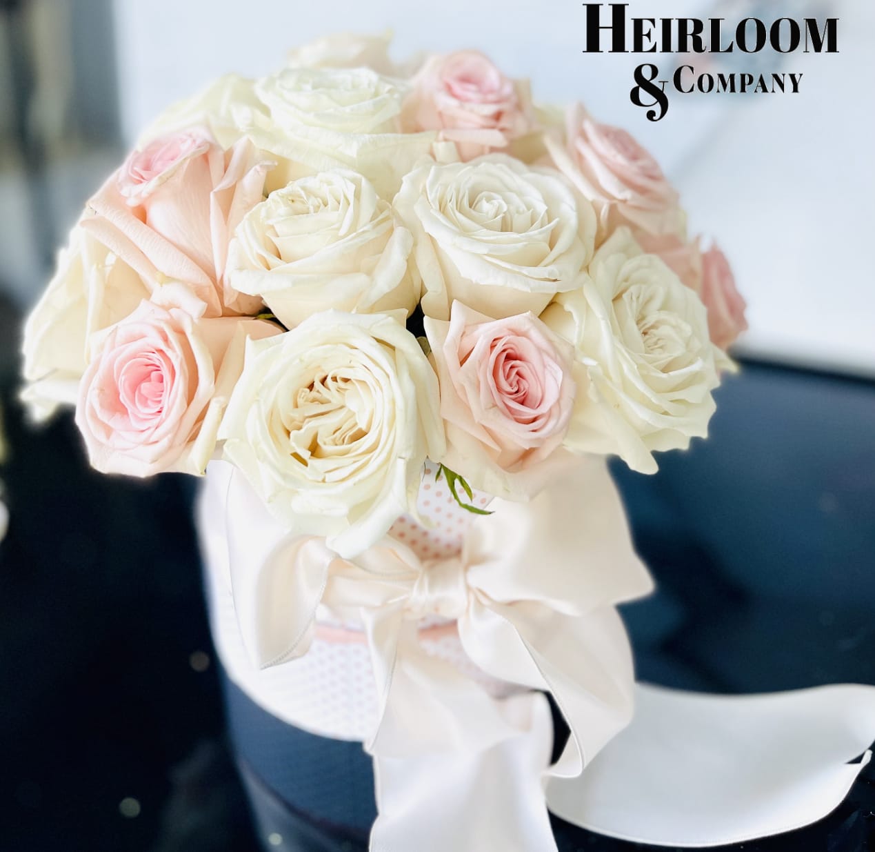 China Doll China Doll - An adorable pink and white polka dot gift box filled with out handpicked blush and white premium garden roses, wrapped with a giant fluffy satin bow.
