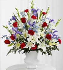 Cherished Farewell Arrangement Cherished Farewell Arrangement - Cherished Farewell™ Arrangement is an elegant display of patriotic beauty to honor your loved one at their final farewell service. Red roses, red carnations, white gladiolus, light blue delphinium, blue iris, white Oriental lilies, white Asiatic lilies and lush greens are elegantly arranged in a white plastic urn to create a stunning way to say your last goodbye. .
