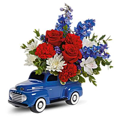 Heyday Ford Pickup Bouquet - The perfect pick-me-up, this vintage ceramic pickup is hand-glazed and filled with fresh flowers for an unforgettable gift. Green carnations, blue delphinium, white daisy spray chrysanthemums, green cushion spray chrysanthemums and blue sinuata statice are arranged with variegated pittosporum and parvifolia eucalyptus. Delivered in Teleflora's '48 Ford Pickup Keepsake. Orientation: All-Around