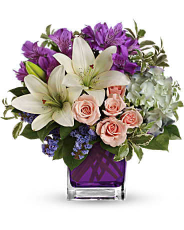 Pretty Pastures - Stunning arrangement of white hydrangea, light pink spray roses, white asiatic lilies, lavender alstromeria,and fresh greens that are perfectly presented in our violet cube.