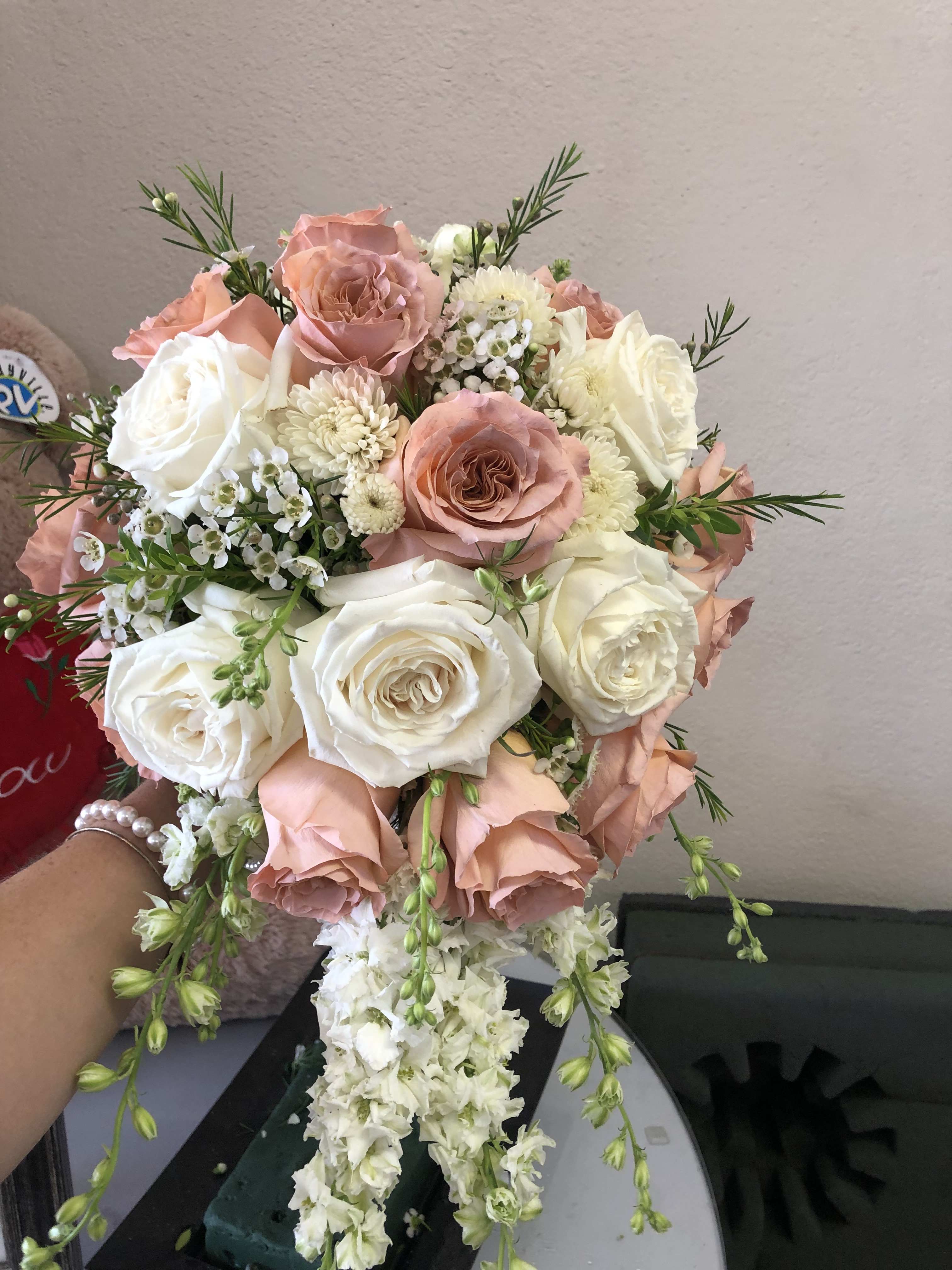 Pink rose bouquet Pink rose bouquet - This stunning bride's bouquet is a cascading bouquet made with ivory, blush pink, and ballet pink roses accented with rose berries. bouquet is approx 10 inches wide and about 18 inches long.