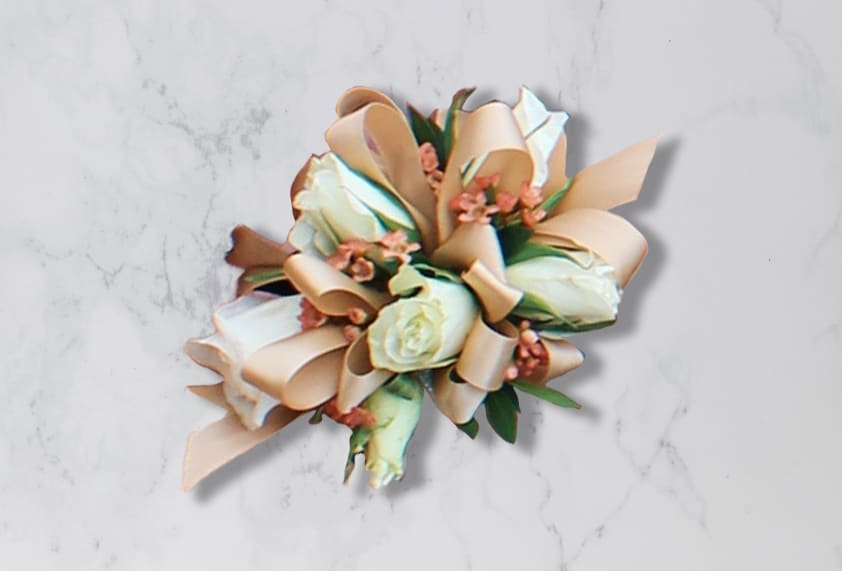 Wrist Corsage of White Spray Roses - Wrist Corsage of White Spray Roses with peach filler flower, greenery on a tan bow.  Colors may vary depending on availability of products