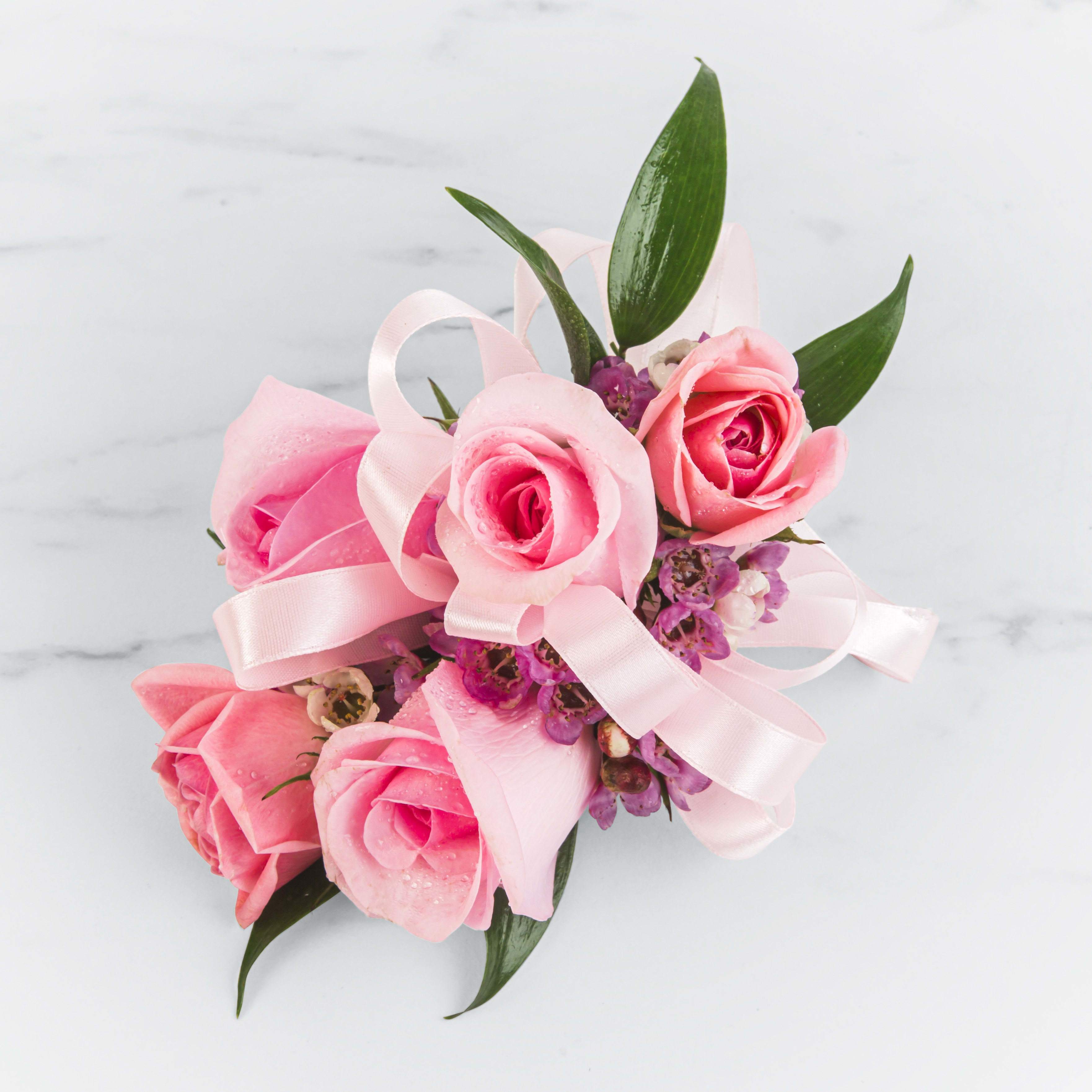 Pink Rose Corsage Pink Rose Corsage - A classic pink corsage hand-tied in pink satin that compliments any outfit. A beautiful addition to any prom, formal, or wedding event. can be in any other color .