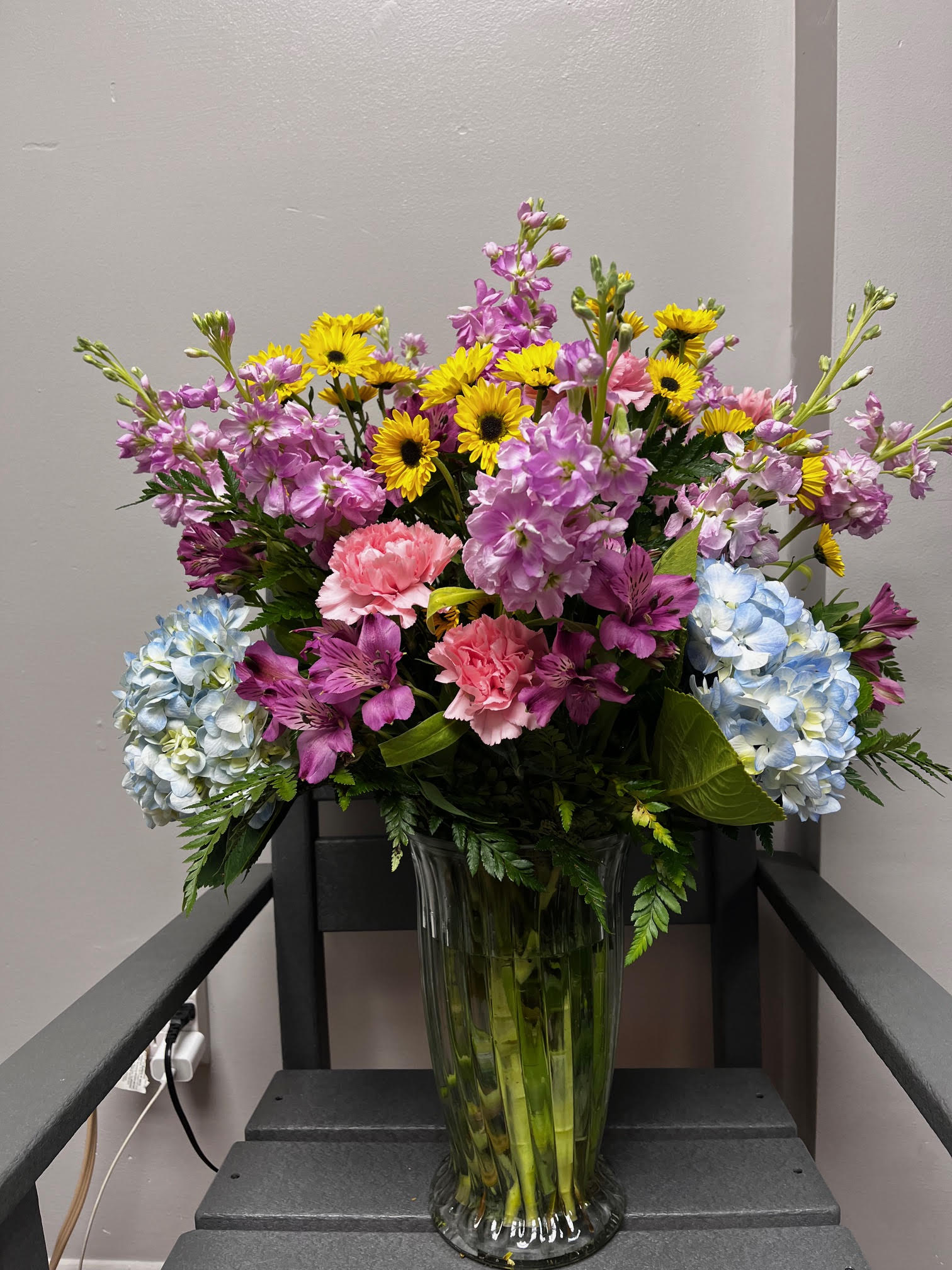 Sumer Celebrations Sumer Celebrations - Celebrate the beauty of summer with all of it's vibrancy and beauty. Stock, hydrangea's, daisies and more all in one tall, impressive arrangement.