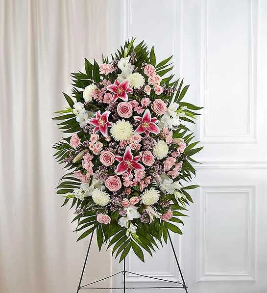 Deepest Sympathies Standing Spray-Pink &amp; White - Product ID: 91285   This Sympathy Standing Spray, in shades of peach, orange and white, is a beautiful symbol of your sympathy and support. Pink roses, stargazer lilies, spray roses, white carnations and more An appropriate gift for family, friends and business associates to send directly to the funeral home Our florists use only the freshest flowers available so colors and varieties may vary Large measures approximately 54&quot;H x 42&quot;L without easel Medium measures approximately 46&quot;H x 38&quot;L without easel Small measures approximately 42&quot;H x 32&quot;L without easel