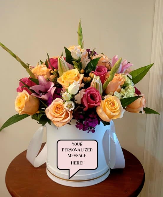 Customized Hat Box - This modern approach will be designed in a hat box, with mixed, in-season blooms, and a brief message to surprise your loved one.   Please note, that no explicit messages or graphics will be designed, For adult messages, age verification will be required from the sender and recipient.