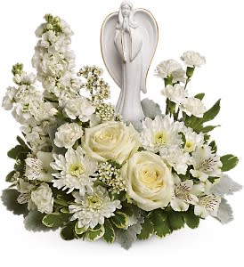 Guiding Light Bouquet - As serene as gently falling snow, this pure white arrangement of roses, astroemeria and stock is a heartfelt symbol of peace and beauty. Its graceful angel keepsake sculpture will remain a guiding light to your loved ones for years to come