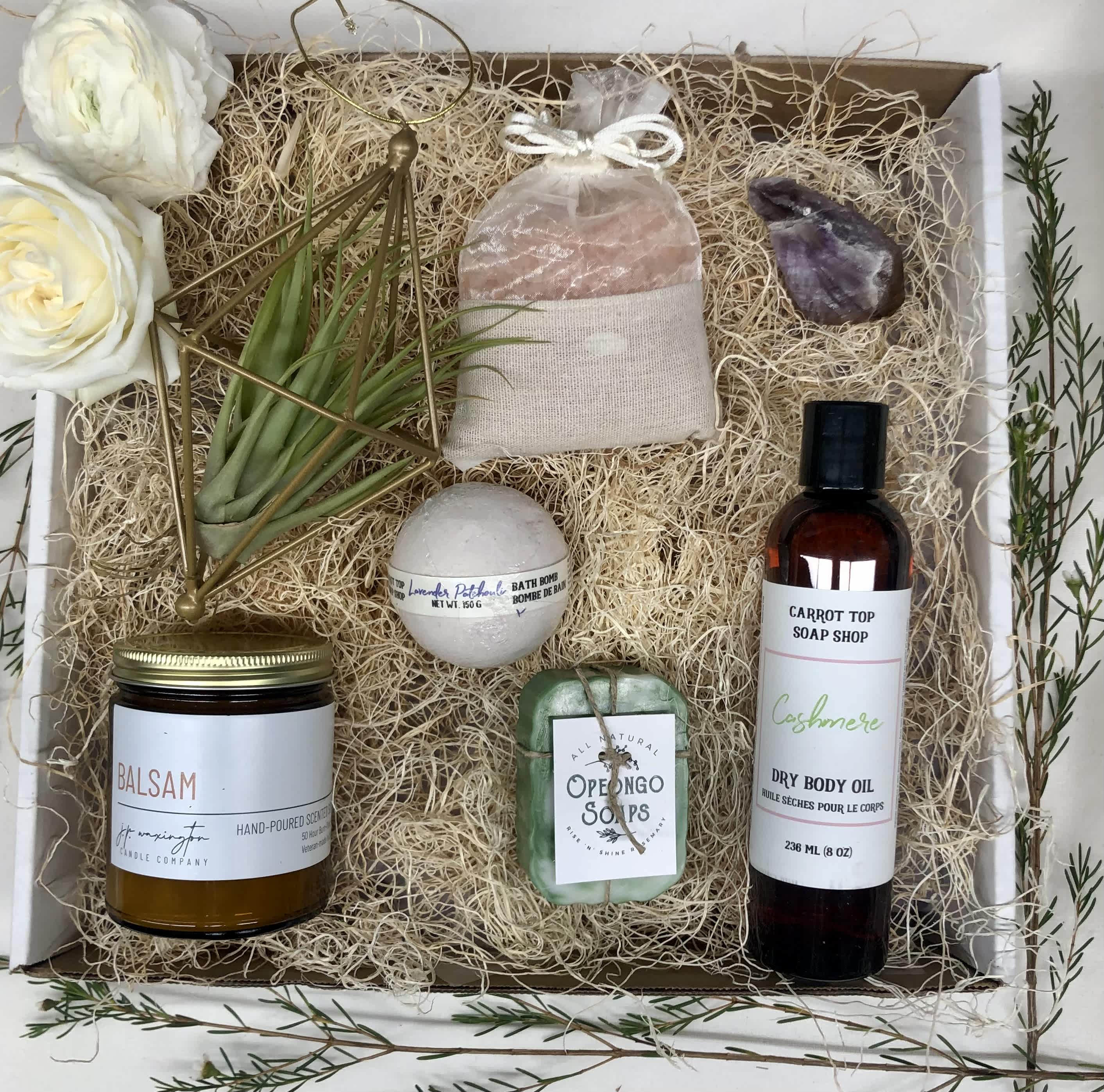 Fresh and Clean Gift Basket - A luxurious bath gift basket to pamper the one you love. Featuring a locally made products such as a candle, bath bomb, soap, and body oil, and completed with bath salts, soap dish, a loofa and an air plant. Deluxe value pictured  