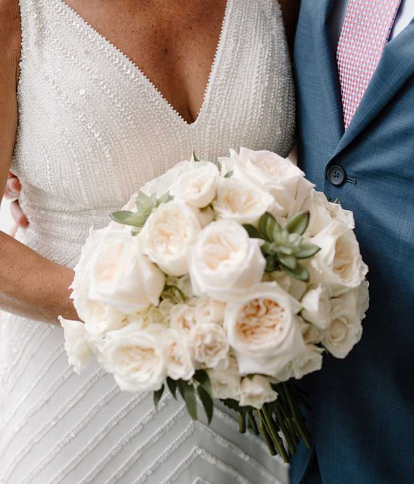 Succulent Simplicity Succulent Simplicity - This gorgeous all white Bridal Bouquet includes fresh flowers such as garden roses, white hydrangea, white majolika spray roses, escimo roses, and is accented in just a few simple echeveria succulents