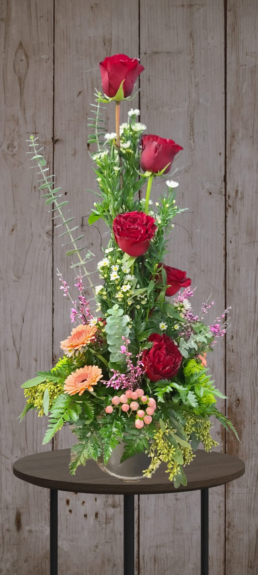 Burgundy &amp; Peach Tin  - Peach Mini Gerbera Red Heart Roses and Hypericum Berries. A stately talking piece that is sure to be noticed. 