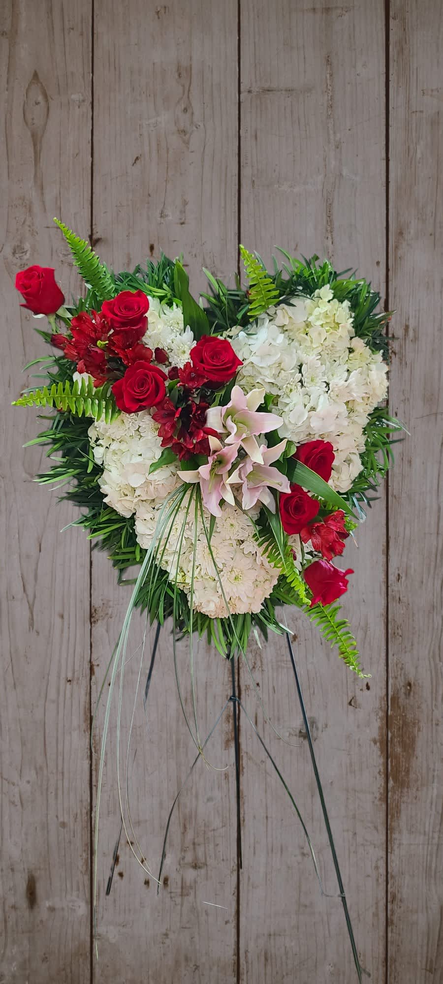 Bleeding Heart Standing Spray Bleeding Heart Standing Spray - Solid heart standing spray expresses your truly heartfelt loss. A tribute that truly speaks to the heart.