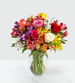 Smiles And Sunshine Bouquet - Bring a rainbow of color to any home with this bouquet. Blooming with an assortment of alstromeria and roses, this vibrant beauty makes the perfect expression for all your special occasions this season.