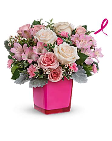 Teleflora's Be The Moment Bouquet - Make any moment magical with this breathtaking bevy of roses, presented to perfection in a hot pink glass cube that lives on as a cute candleholder. CrÃ¨me roses, pink spray roses, pink alstroemeria and miniature pink carnations are arranged with white waxflower, dusty miller and oregonia. Delivered in a Color Splash Cube.