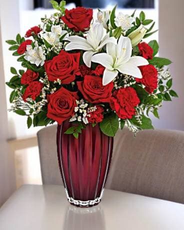 Modern Lovely - Perfect for any occasion let the roses speak for themselves, roses, lilys and asltromeria in red glass vase Approximately 16w x 18 h