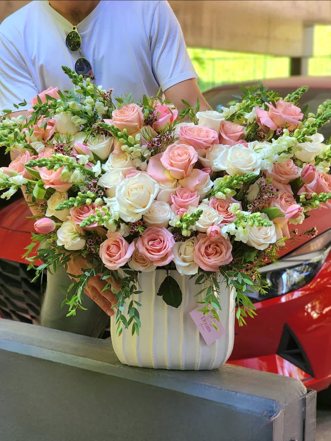 Still Into You - Delicate and light arrangement in a white ceramic vase with pink and white roses, slightly touched with greenery symbolizes the strongest, purest and strongest feelings and best wishes  Disclaimer: ALL IMAGES PROVIDED AT DELUXE PRICE  