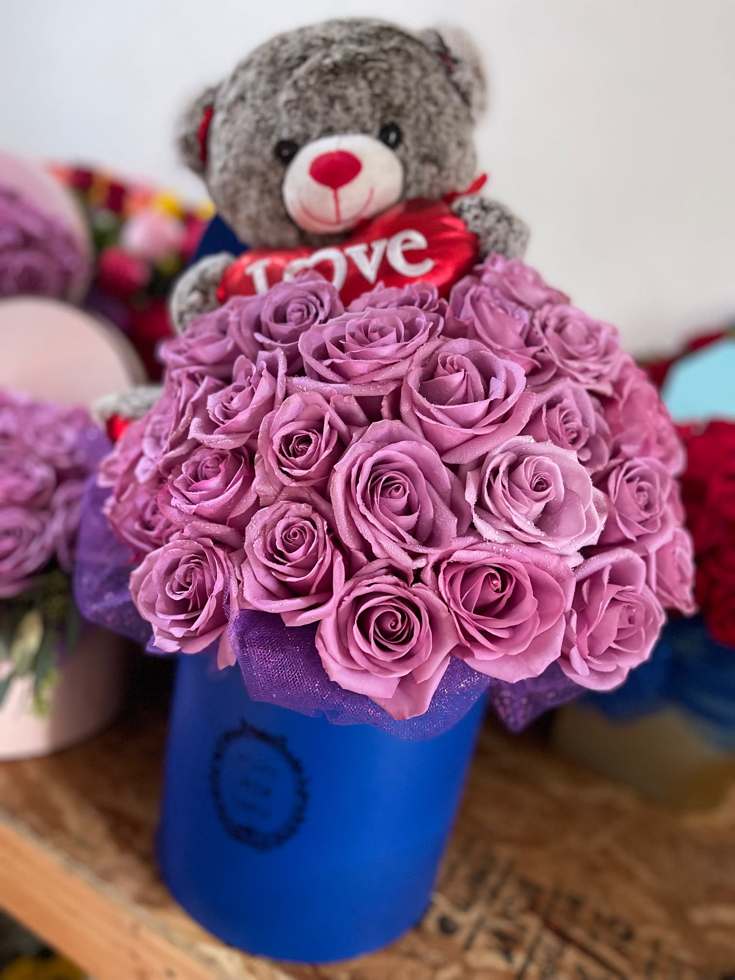 Rose Box with Plush Rose Box with Plush - HEART SHAPED BOX FILLED WITH FRESH CUT ROSES AND ACCENTS OF ASSORTED GREENERY. ROSE COLOR(S) CAN BE SELECTED BY THE CUSTOMER. PLUSH BEAR INCLUDED (STYLE MAY VARY)