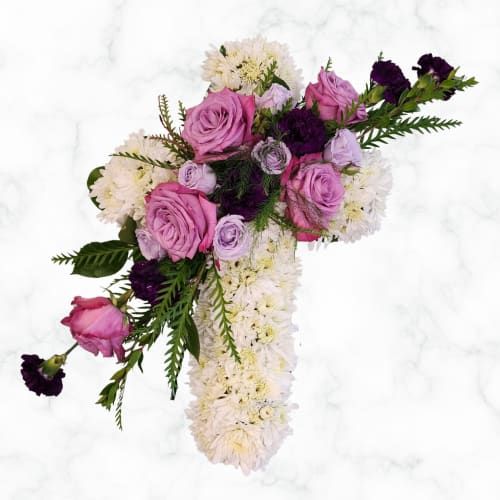 Peace and Prayer Cross Standing Spray Peace and Prayer Cross Standing Spray - At Specialty Floral Design, we pride ourselves on creating one-of-a-kind floral arrangements that truly reflect the sentiments of the occasion. Our Peace and Prayers Cross Standing Spray is a beautiful and elegant tribute, designed to offer comfort and convey your heartfelt condolences. This standing spray features a stunning combination of white cushion mums and lavender and purple roses and carnations, arranged in the shape of a cross. The serene white mums symbolize peace and purity, while the rich hues of the roses and carnations add a touch of elegance and warmth. We understand that each tribute should be as unique as the individual it honors. If you would like to customize the colors or make any other adjustments to this arrangement, we are more than happy to accommodate your requests. Simply give us a call at 360-688-6608, or add your comments in the special instruction box when placing your order on our website. We will verify with you to ensure we have the correct information and that your arrangement perfectly meets your expectations. Ordering funeral flowers serves two important purposes: For Family and Friends: Flowers provide a sense of peace and help soothe the grief during this difficult time. They create a comforting atmosphere for your family and friends attending the service. For the Deceased: Flowers honor, love, respect, and celebrate the life of your loved one. They serve as a beautiful tribute to their memory and express your heartfelt condolences. Our Delivery Services Specialty Floral Design delivers to several locations, including: Mills & Mills in Tumwater, WA Woodland Funeral Home in Lacey, WA Alternatives Funeral Home in Olympia and Lacey, WA We also deliver to many churches and venues surrounding Thurston County. The Peace and Prayers Cross Standing Spray is a perfect choice for both church services and funeral home services, providing a dignified and beautiful expression of sympathy and support. Trust us to deliver a memorable and meaningful tribute that will bring peace and comfort during difficult times.