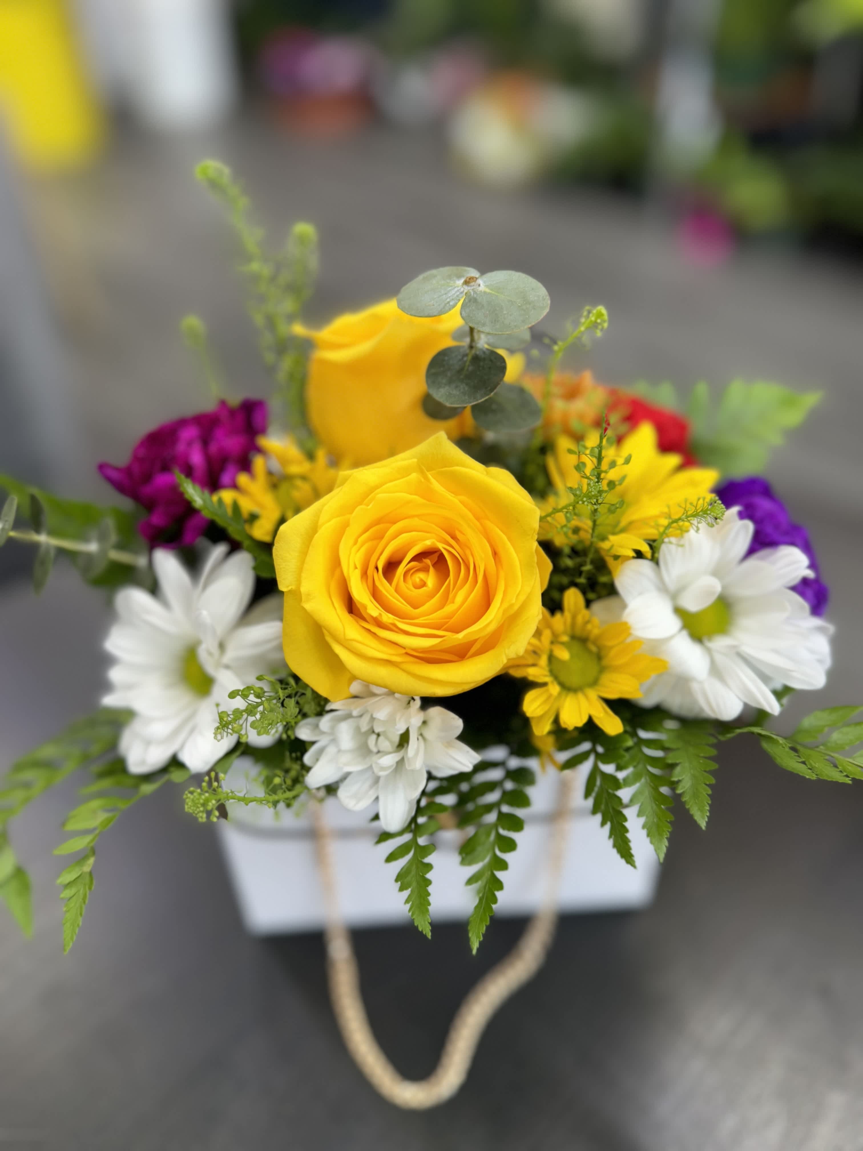 Sunshine Purse Bouquet Sunshine Purse Bouquet - "Discover the elegance of our Sunshine Purse Bouquet, where vibrant yellow blooms intertwine with a stylish purse arrangement. Perfect for adding a touch of sunshine and sophistication to any occasion, this unique floral creation blends beauty with practicality, making it a delightful gift”