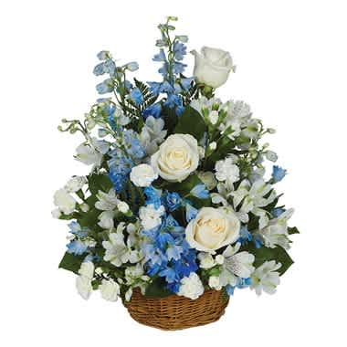 Peaceful Wishes Basket - Tranquility is the word that immediately comes to the forefront in describing this serene yet exceptional floral creation of blue delphinium, white roses, white mini carnations and white alstroemeria in a willow basket. Measures 18&quot;H by 14&quot;L.