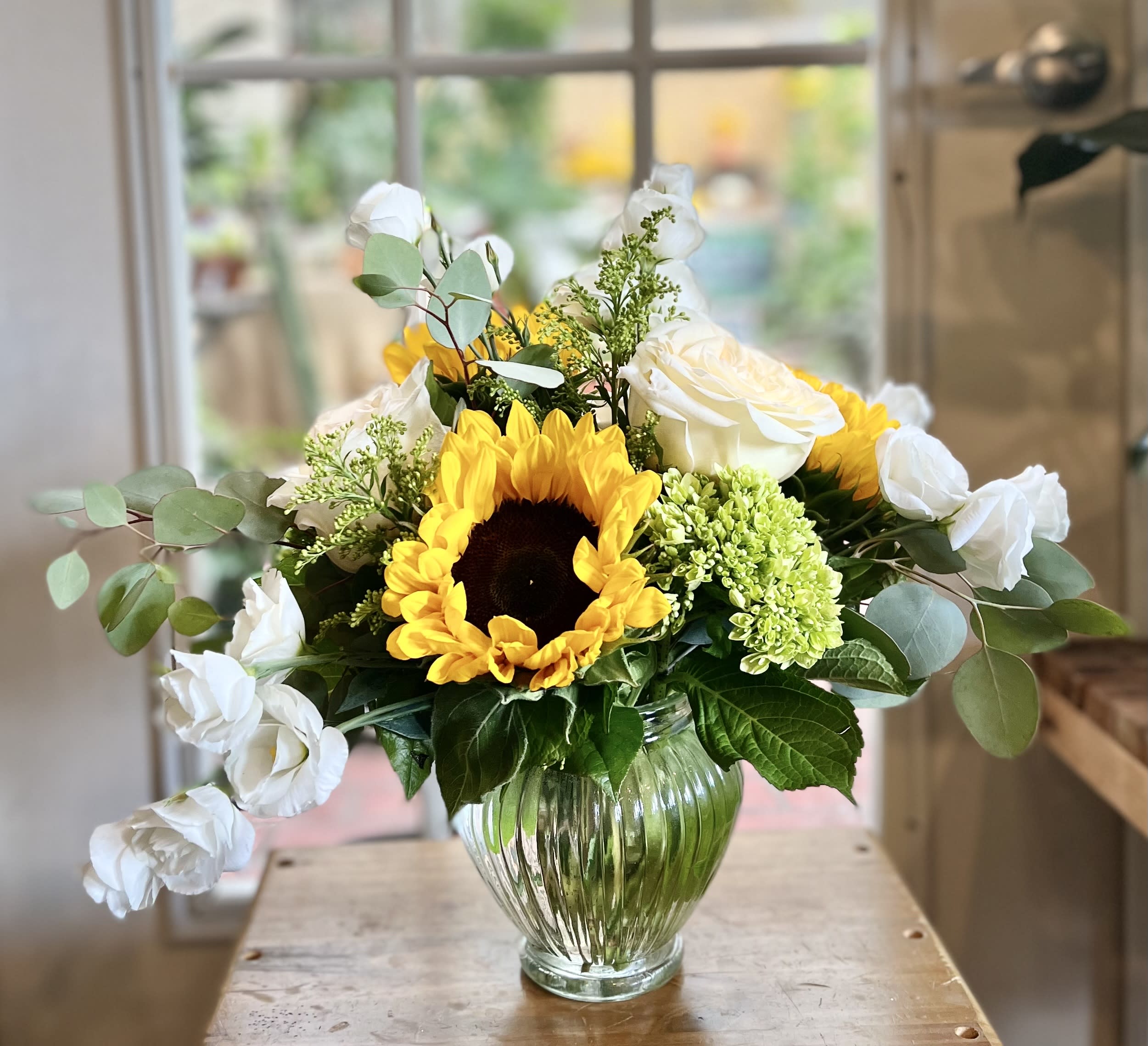 Timeless - Our summer special includes sunflowers, white roses, and green hydrangeas! 