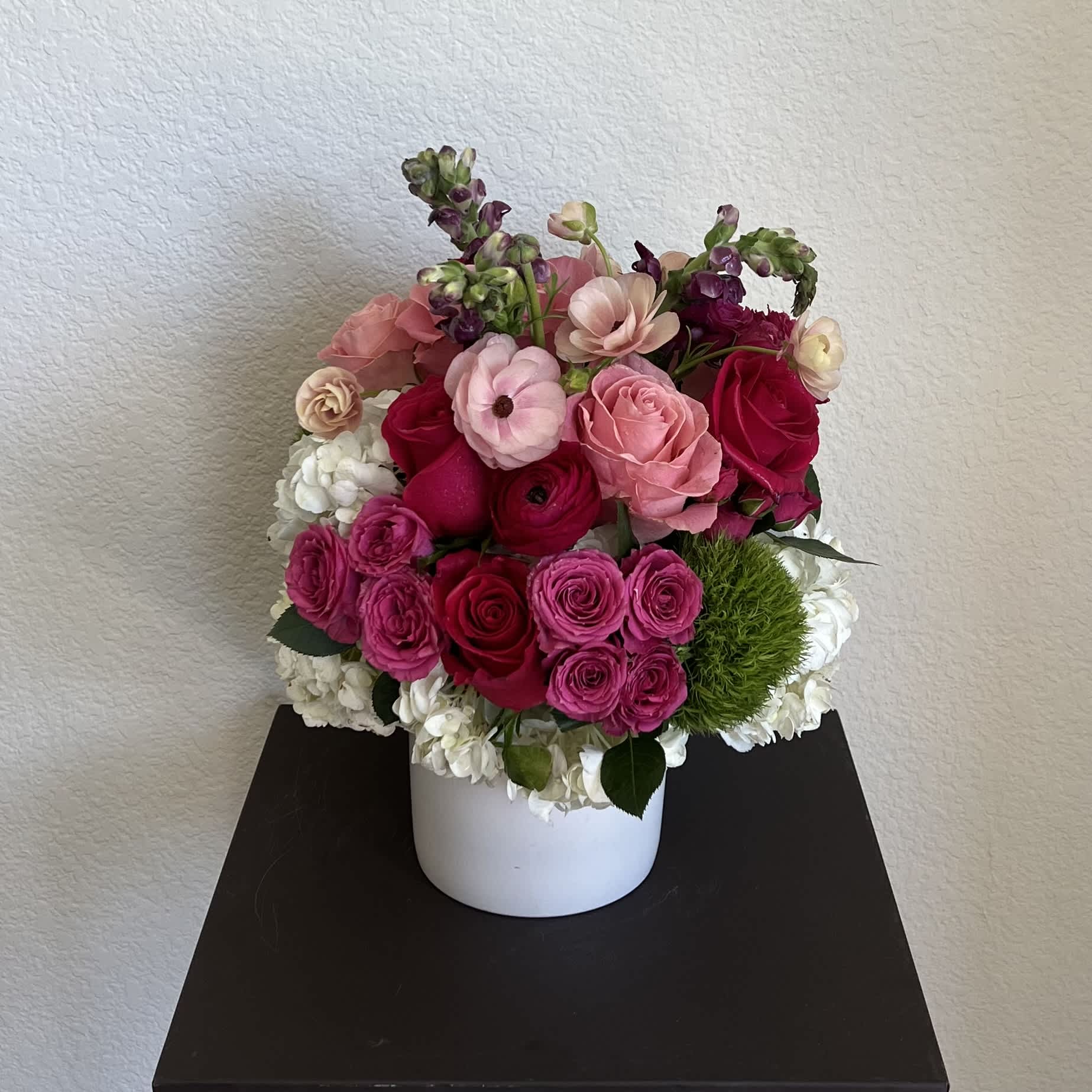 TAYLOR - this floral arrangement is designed in a white ceramic vase. This design has a mix of premium flowers lile roses, hydrangeas, and more. Flowers delivery available in the danta clarita Valley and surrounding cities