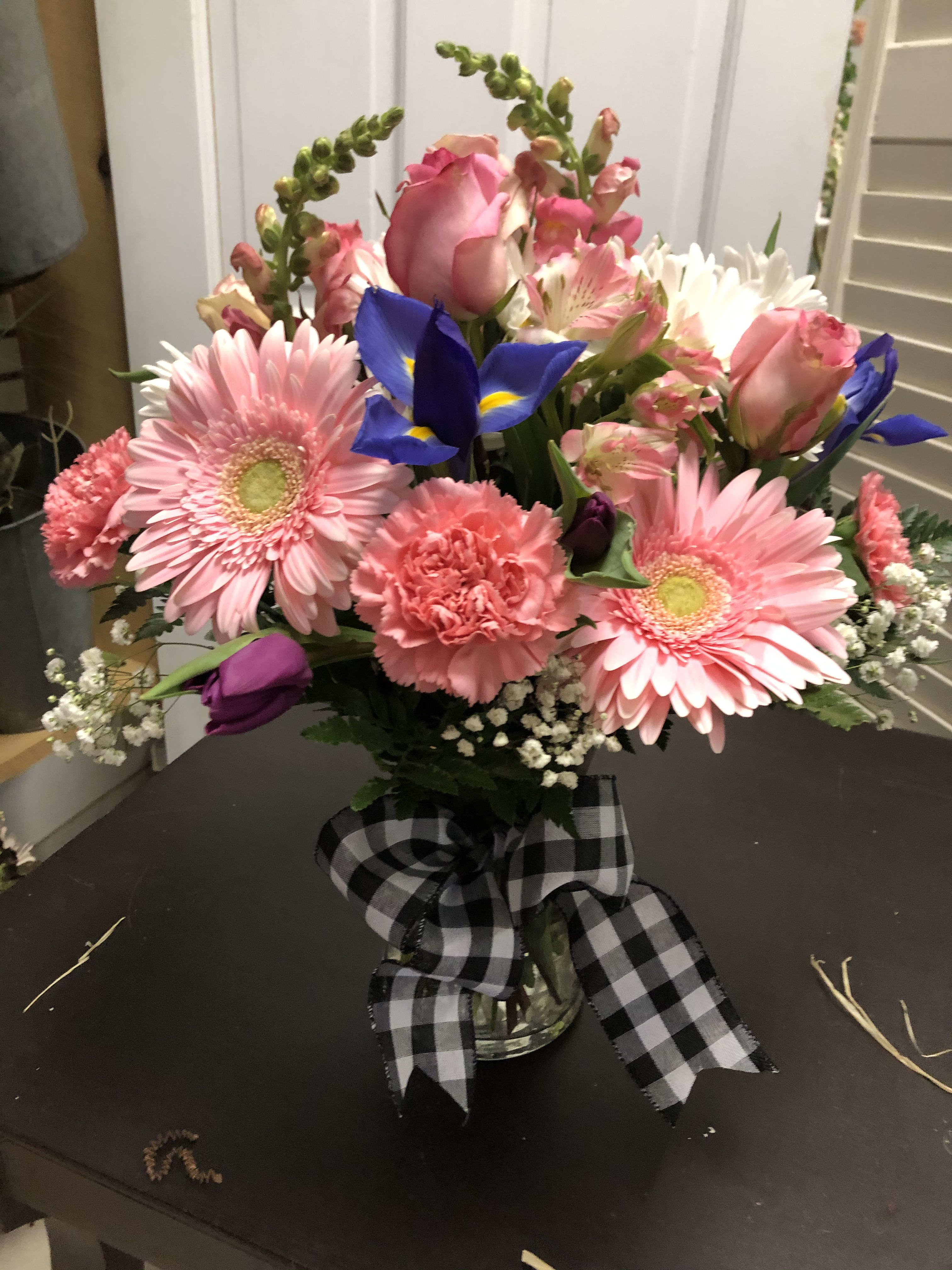 26 26 - Everyday delight. Gerbera daisies, carnations, snapdragons, irises or other seasonal flower in a glass vase. This everyday delight will serve as a beautiful pick me up, or a thinking of you. $50.00+