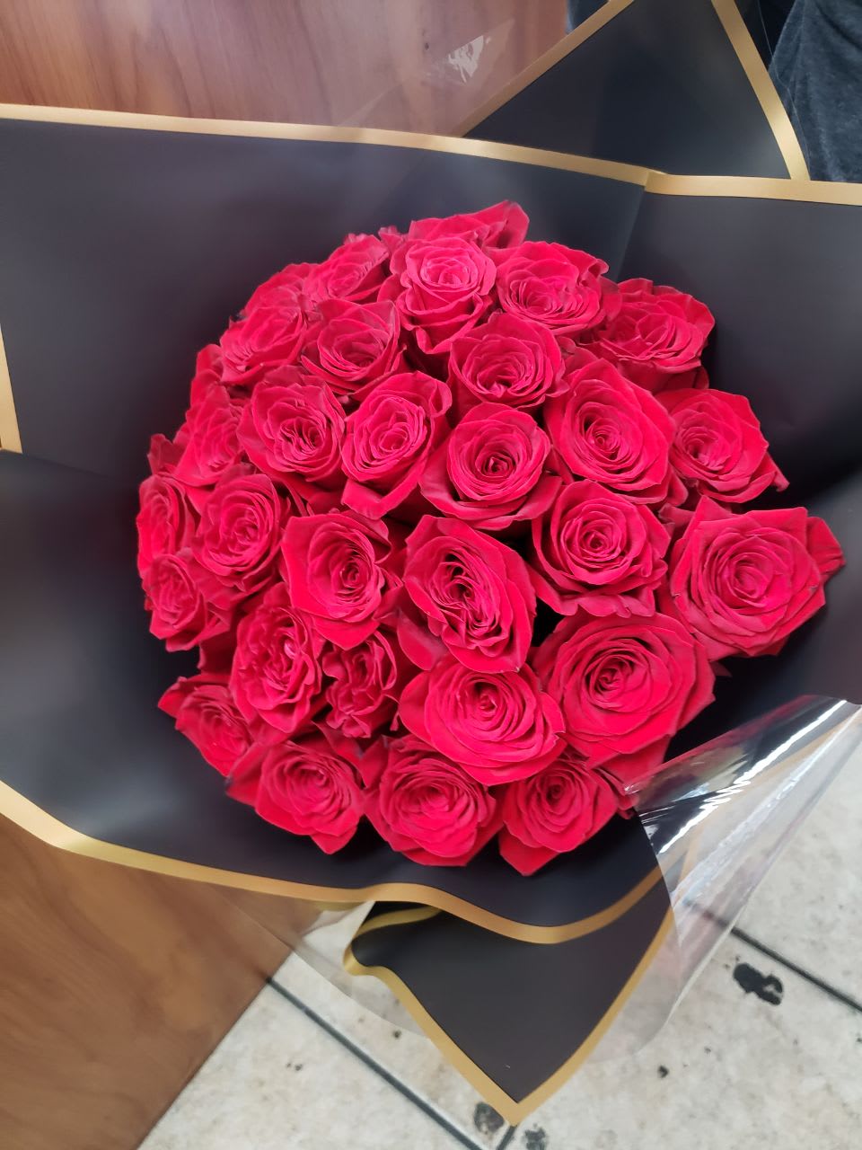The Amour Bouquet  - 30 stems of gorgeous red roses   with  black  wrapping  and a red bow as a special touch  