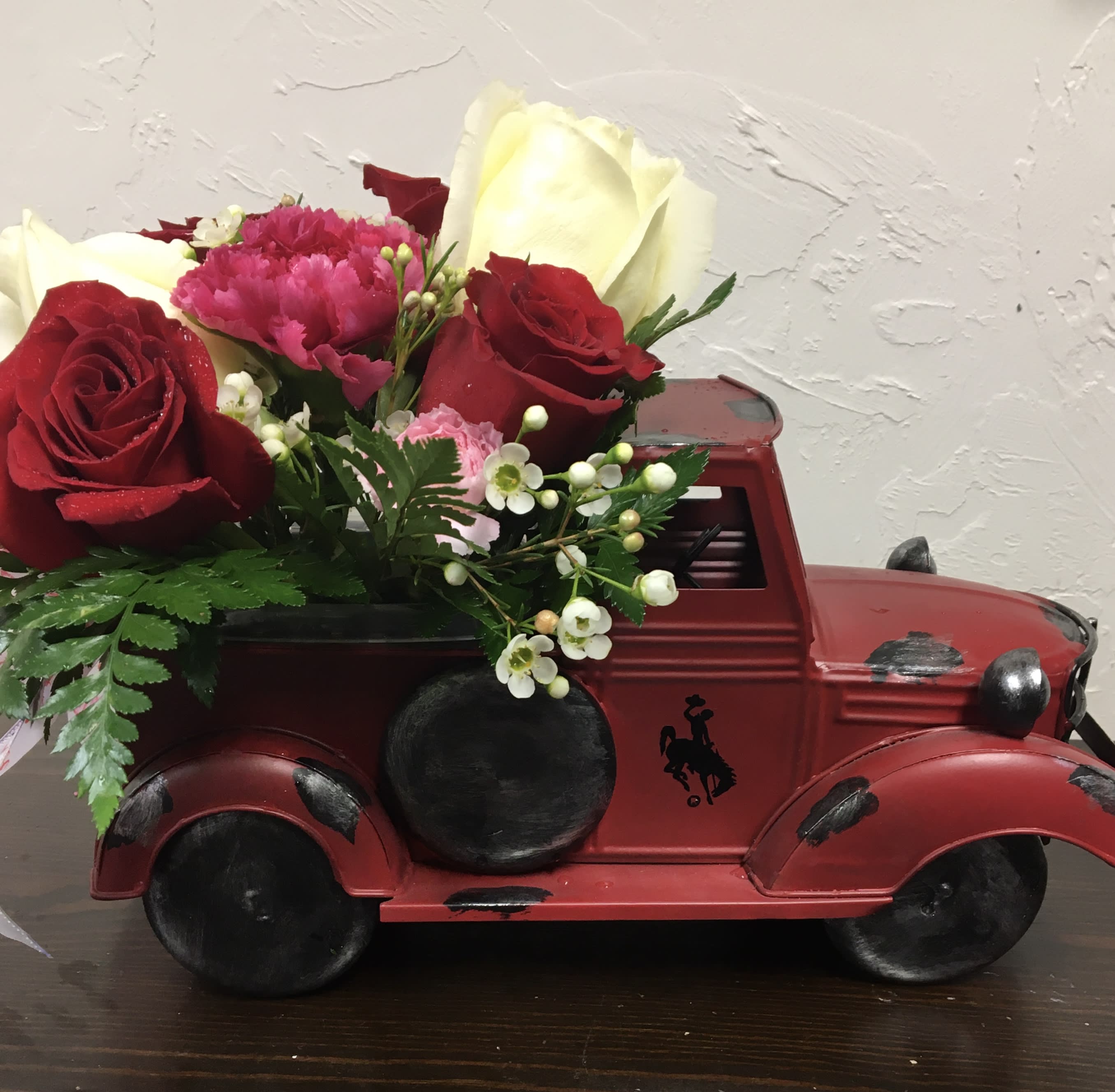 Old Red truck Floral Arrangement - Old time metal truck with roses, carnations greenery, or you can pick others