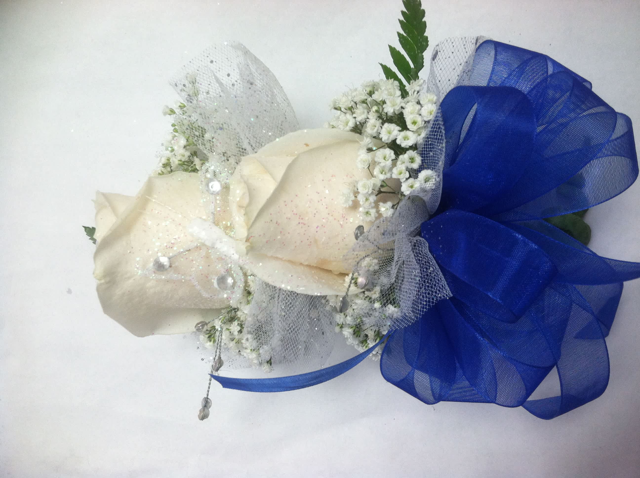 White Rose Corsage by BloomNation™  - A classic white corsage with silver sheer ribbon, this wrist arrangement looks good with any outfit. A perfect compliment to any prom, formal, or wedding event. 