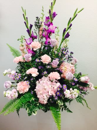 Lilac Tribute  Lilac Tribute  - Item # TLS-S102 Beautiful arrangement in shades of lilac and soft pink colored flowers to include Roses Glads Carnations and Hydrangea accented with lush vibrant greens to create a simply stunning display in a contemporary basket.
