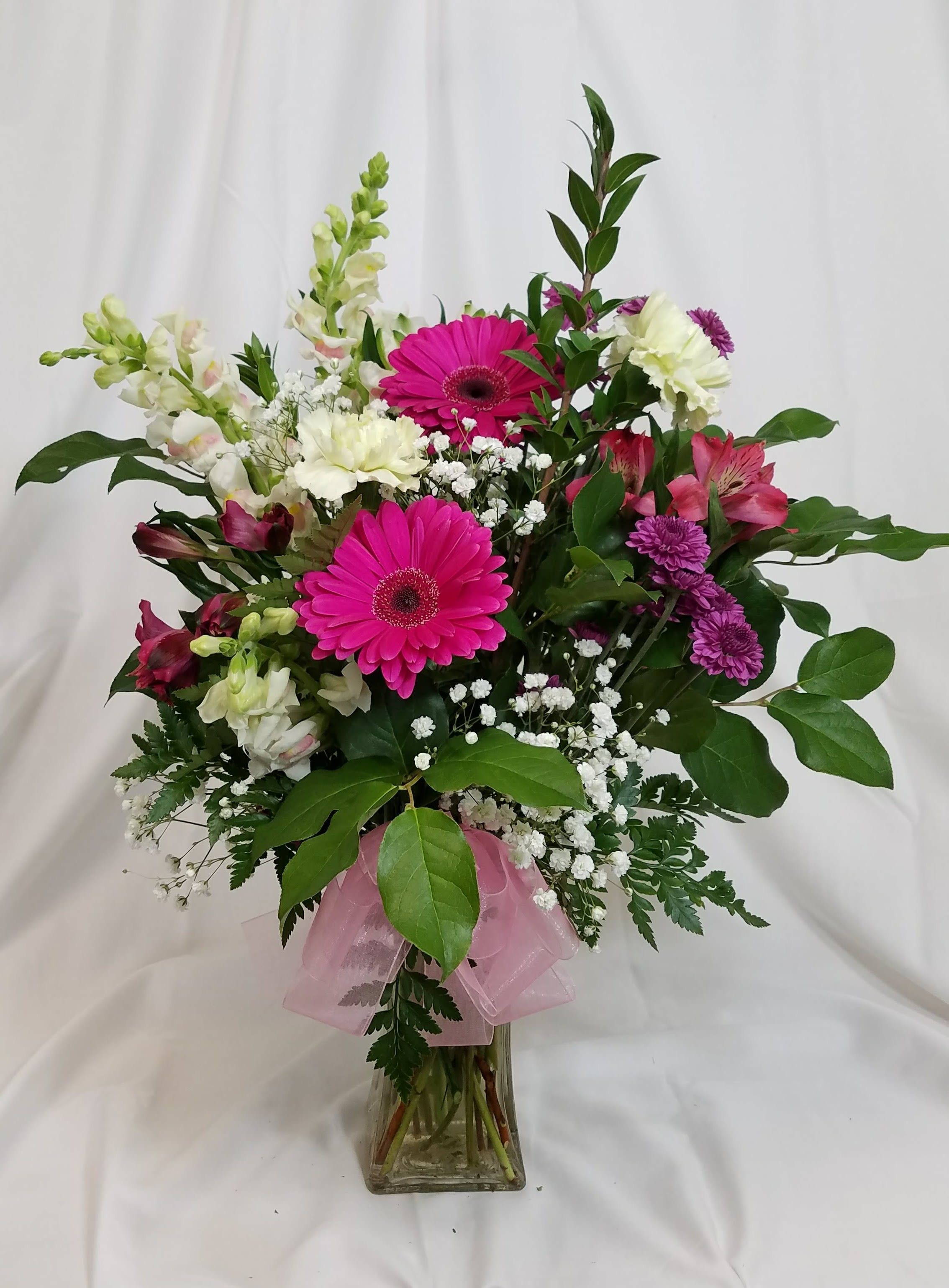 Designers choice - Bright & Cheery Designers choice - Bright & Cheery - Flower choices and colors vary based on season. The is a sample piece to demonstrate size and style.