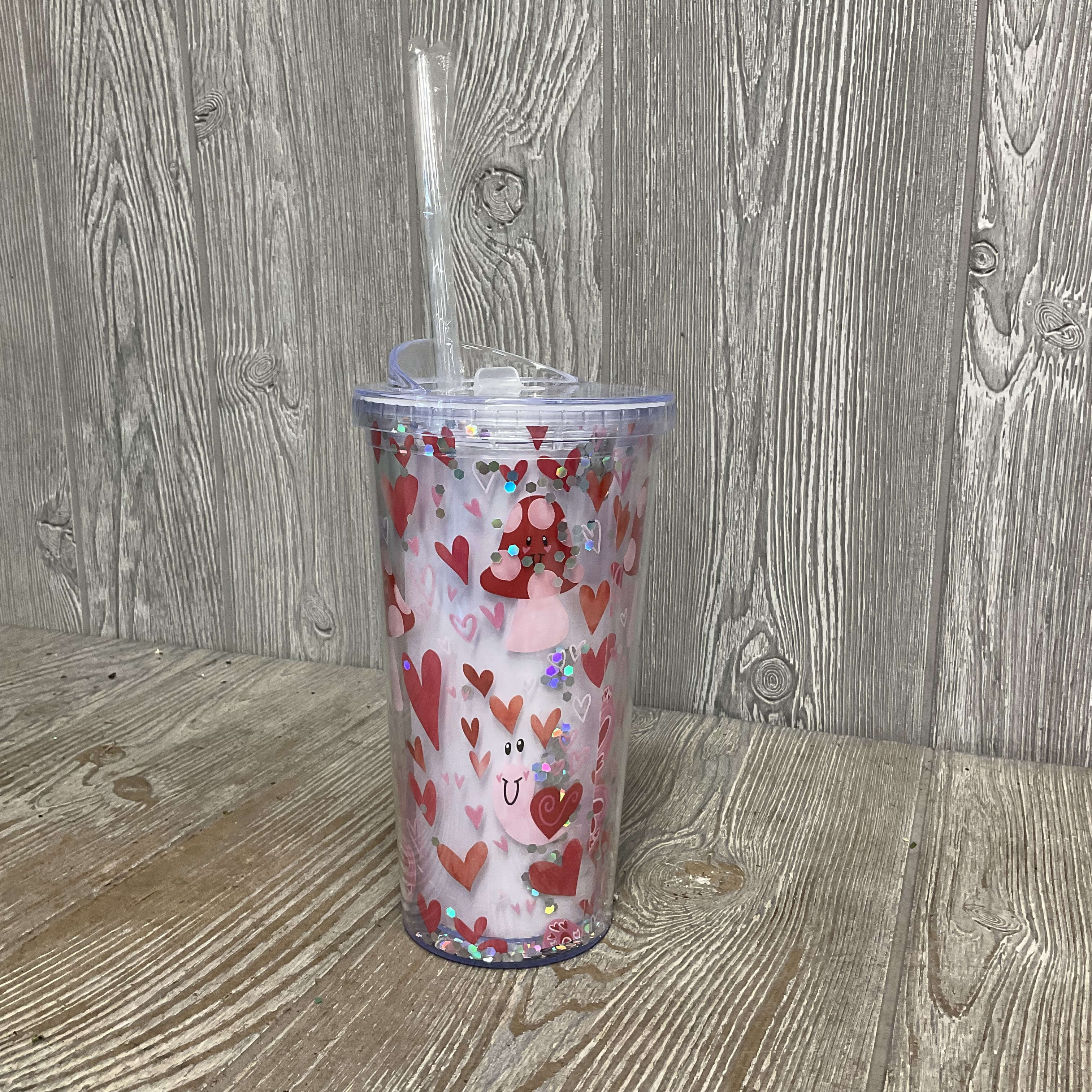 Valentine’s Snail Tumbler  - Acrylic travel cup with fun smiling snails, mushrooms, and butterflies. There are pink and red hearts floating all around. Clear lid and clear straw. 7.5&quot;H X 3.25&quot;Opening, 20 Ounces
