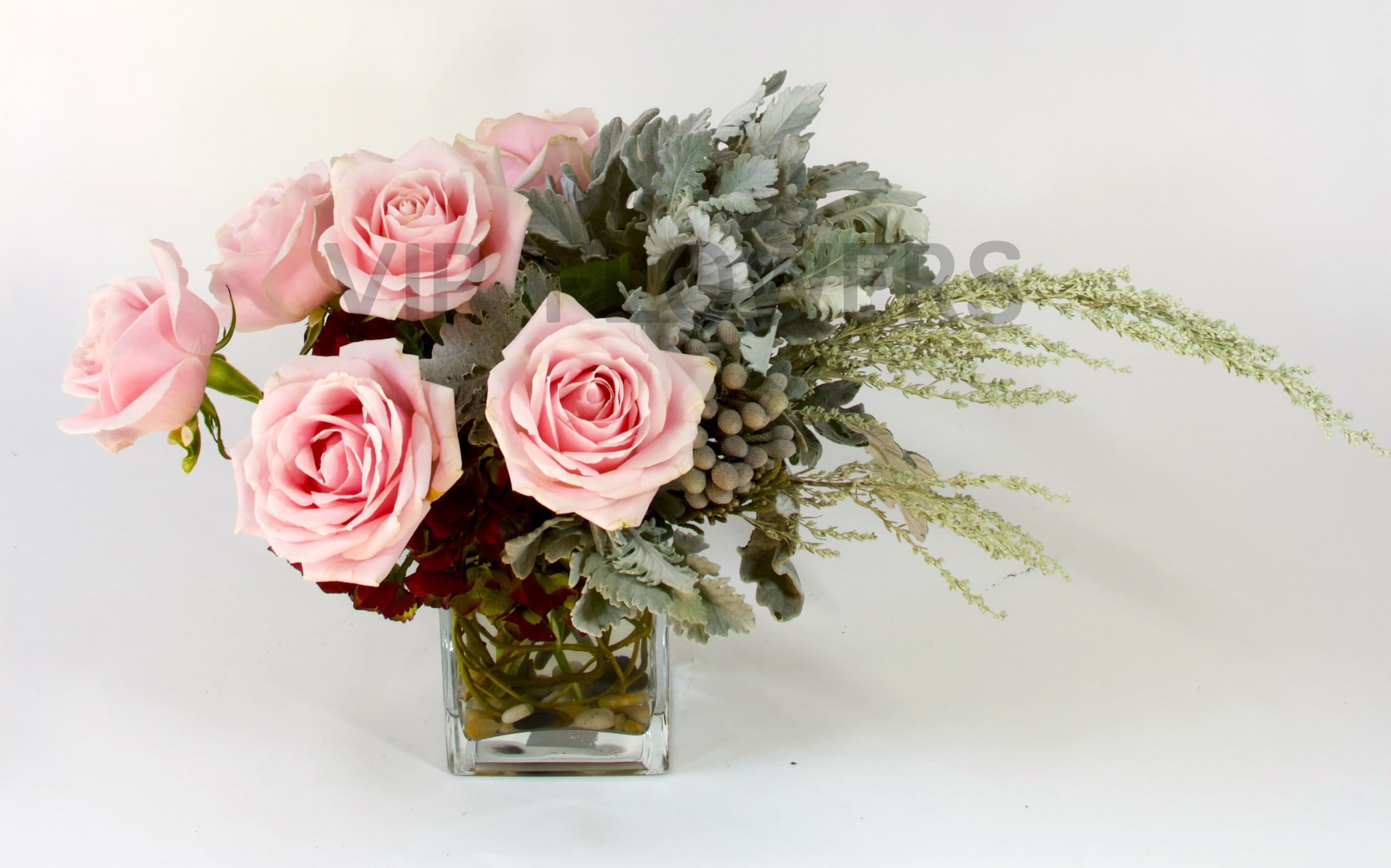 Pink Candy - Truly an inspiring floral arrangement full of beauty! As the pink roses flow alongside the vase, and greens. Simply an elegant blend of flowers.      Substitutions may be necessary to ensure your arrangement or specialty gift is delivered in a timely manner. The utmost care and attention is given to your order to ensure that it is as similar as possible to the requested item (Please note that some flowers and colors may vary due to seasonality.)
