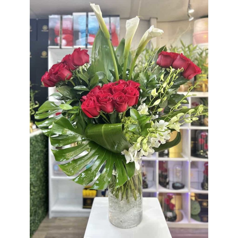 3 Bundles of Love Bouquet (3doz) - Red - 3 Bundles of Love Bouquet: 3 Dozens of love roses arrangement accented with calla lilies, monsteras leaves, and greens displayed in a cylinder / square vase.