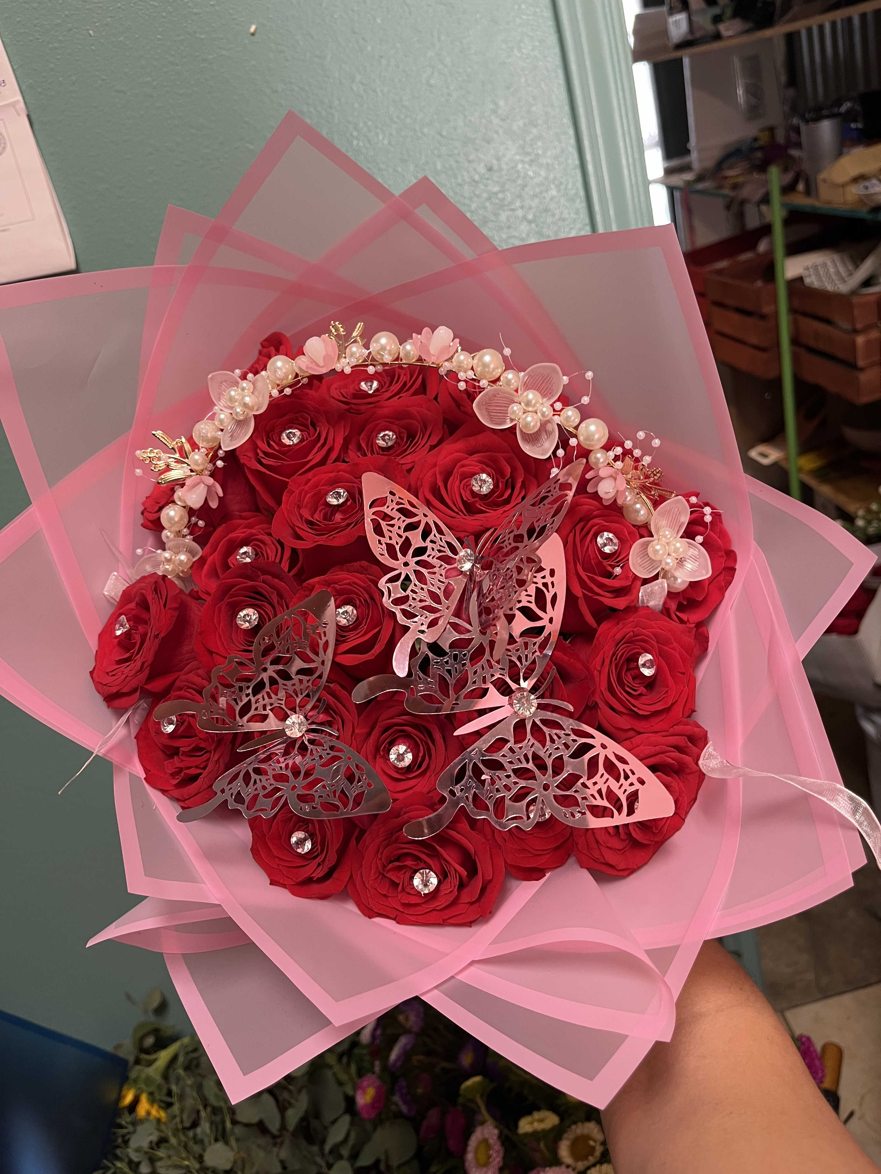 Extravagant buchon  - 25 Red roses with diamond pins, crown, and butterflies we have available in white red and pink roses Choose your color of wrap 