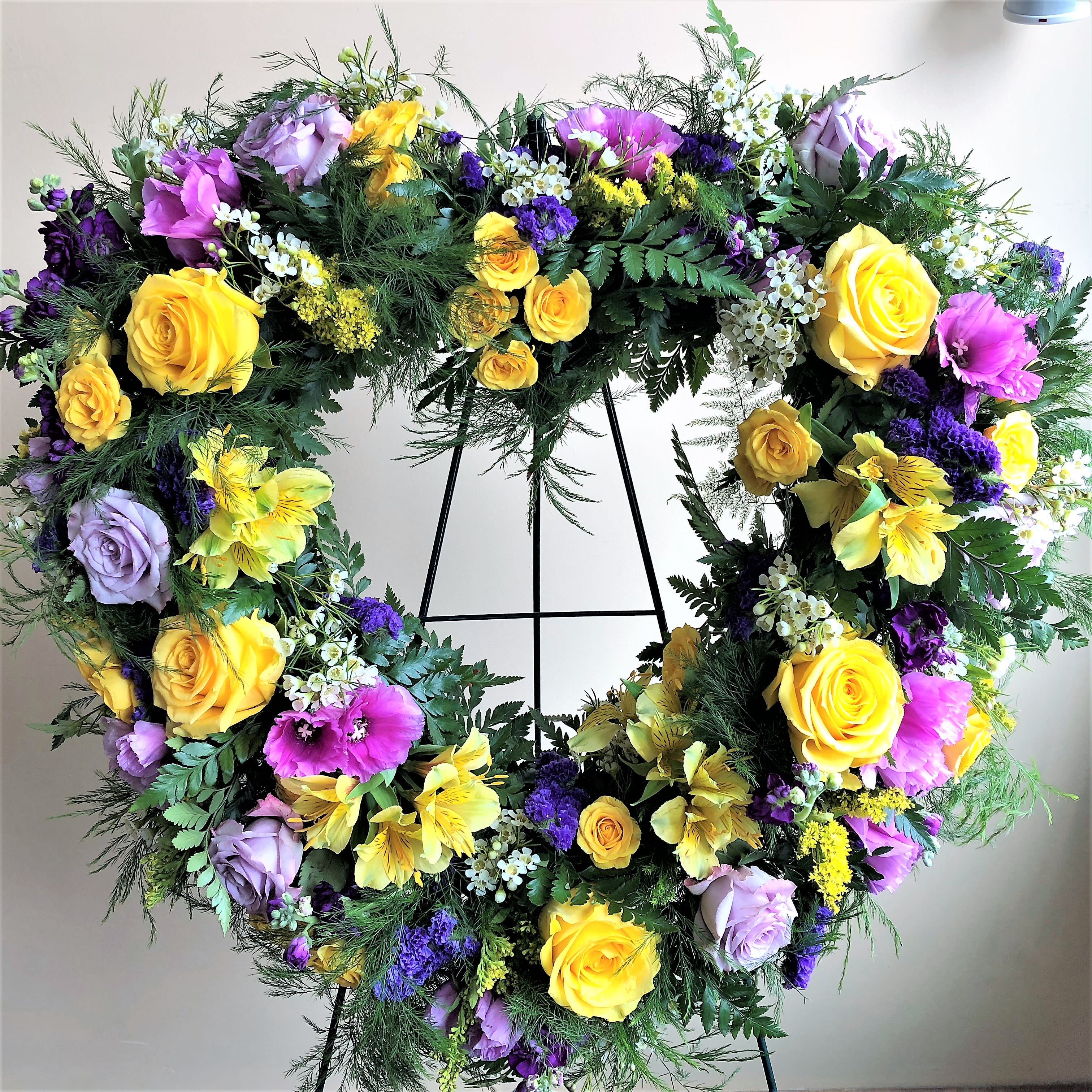 The Ruth Sympathy Heart by Simply Fresh Flowers (72 hour notice required) - A beautiful floral standing heart designed with roses in lavender &amp; yellow &amp; an assortment of premium blooms. Please call the shop directly to inquire about alternate blooms or colors 315-692-2098. Please note***this design requires 72 hour notice***