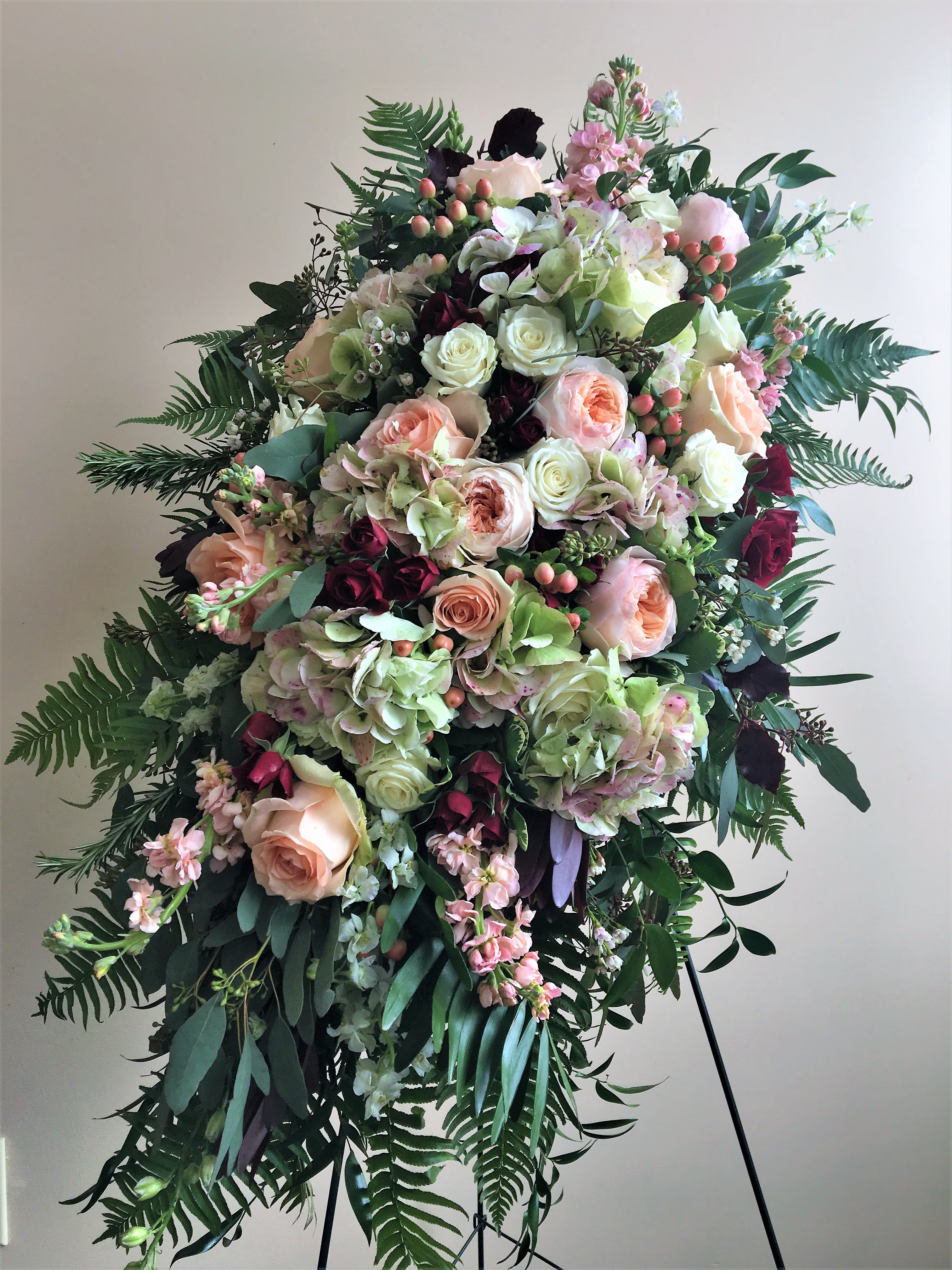 The Kahala sympathy spray by Simply Fresh Flowers (requires72 hour notice) - The Kahala is a truly gorgeous standing, sympathy spray.  It boasts an abundance of blooms including antique hydrangea, Kahala roses, peach &amp; white roses, burgundy spray roses, stock, hypericum berries, accent blooms...eucalyptus and fern complete this design.  A simply soft &amp; lovely sentiment of sympathy for someone very special. Please note***this design requires 72 hours notice***