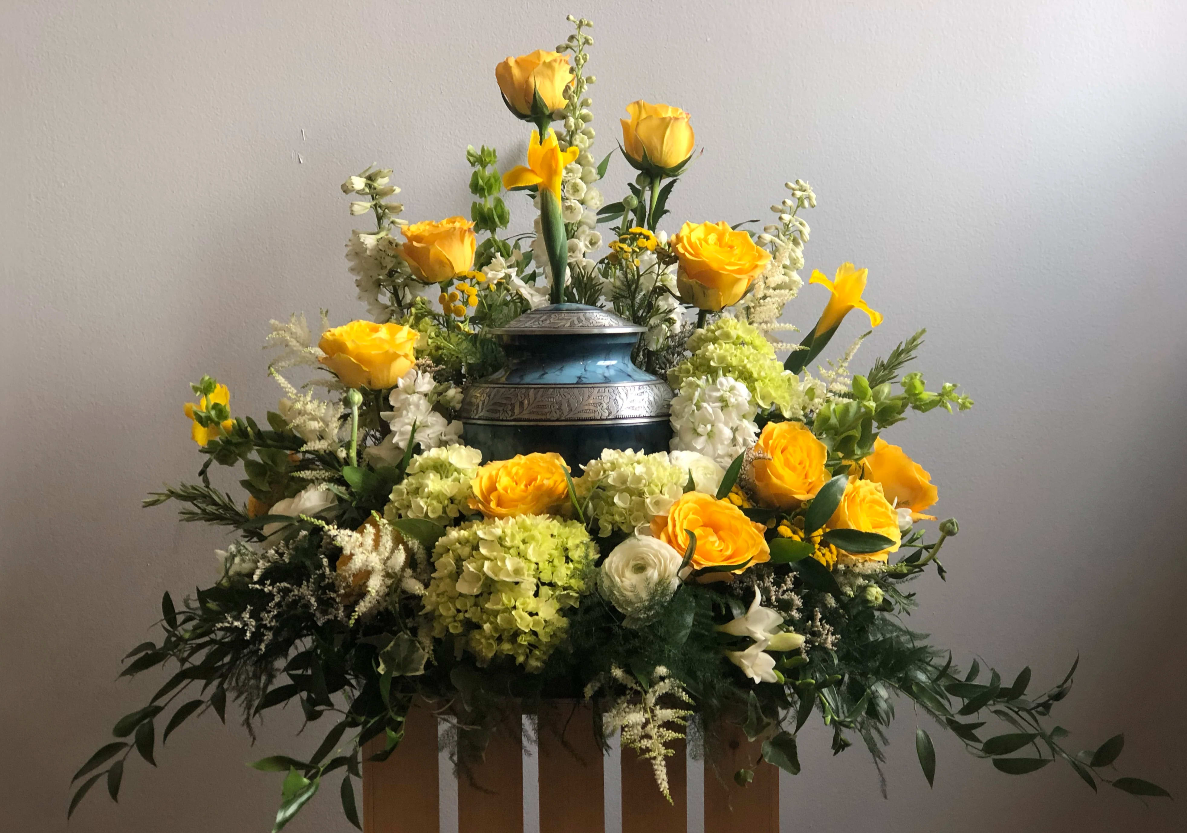 The Warm Embrace, Cremation Urn Floral Surround by Simply Fresh Flowers (72 hour notice required) - A beautiful, bespoke floral, sympathy piece designed to embrace the urn of your loved one. This is a custom item &amp; we'll need to discuss with you.  Available as shown in yellow, white &amp; green or in virtually any color palette you desire. Please phone us at the shop directly to discuss alternate blooms , colors &amp; urn size, we're here to help...315-692-2098. Please note***This design requires 72 hours notice***