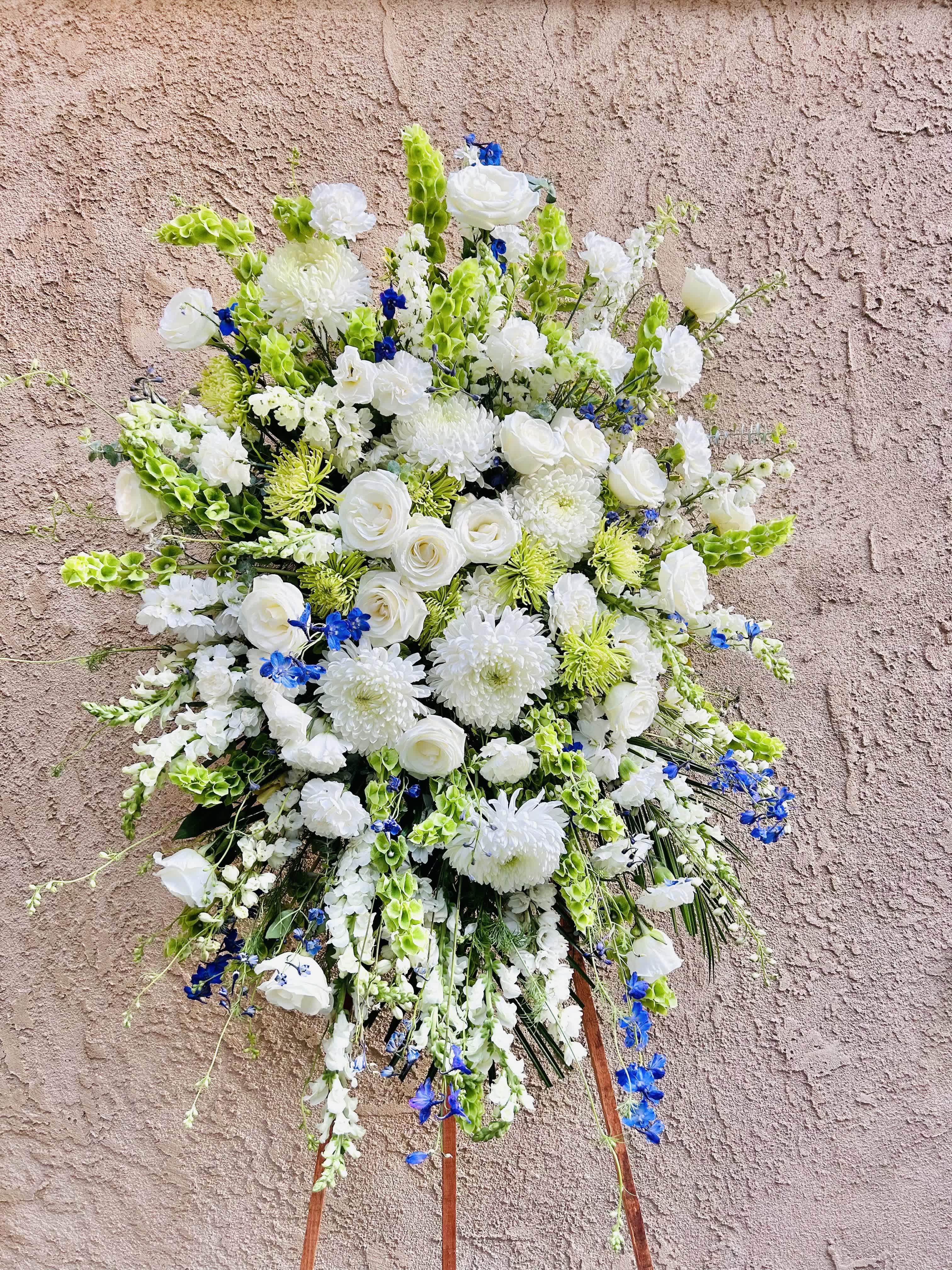 Snowy Serenity - Beautiful spray arrangement featuring chrysanthemums, gladiolus, roses, and blue delphinium 