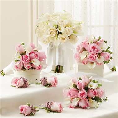Pink And White Personal Package (1 White Bridal Bouquet, 3 Bridesmaid Bouquets And 4 Boutonnieres Pink And White Personal Package (1 White Bridal Bouquet, 3 Bridesmaid Bouquets And 4 Boutonnieres - These hand-designed, Springtime bridal arrangements arrive fresh from our premier florists and include: 1 White bridal bouquet, handcrafted from 18 pink roses, 12 white miniature Calla lilies and variegated pittosporum, tied with a crisp white ribbon; you may also choose an all-white bridal bouquet 3 Pink bridesmaids bouquets, featuring 10 pink roses, 5 white miniature Calla lilies and variegated pittosporum, tied with a white satin ribbon 1 Pink boutonniere featuring a light pink rose boutonniere arrangement, artfully designed by our expert florists and accented with solidago and variegated pittosporum for the Groom 3 Pink boutonnieres featuring light pink roses and accented with solidago and variegated pittosporum for the Groomsmen Orders must be placed two weeks in advance to allow for processing