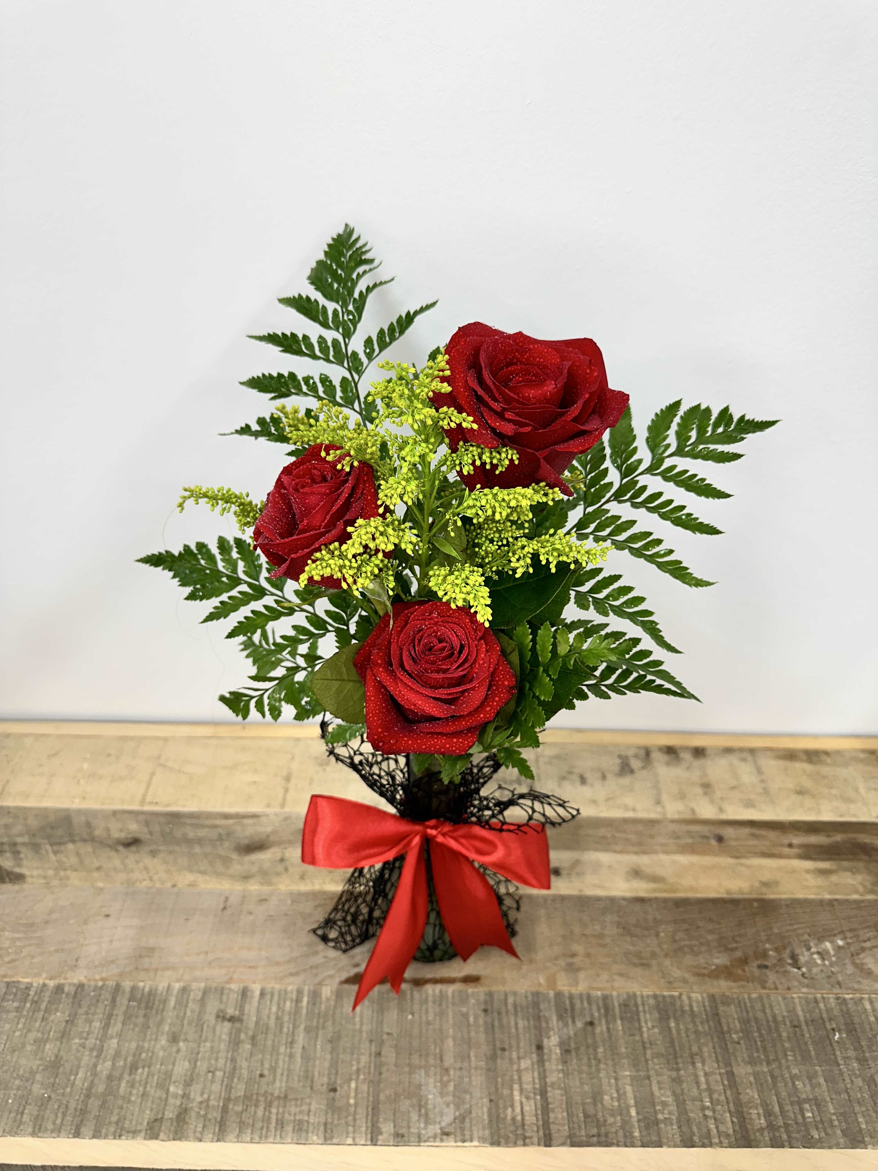 Timeless Trio - &quot;Timeless Trio&quot; features a small vase with lush greenery, elegantly showcasing three stunning red roses for a classic and sophisticated touch.
