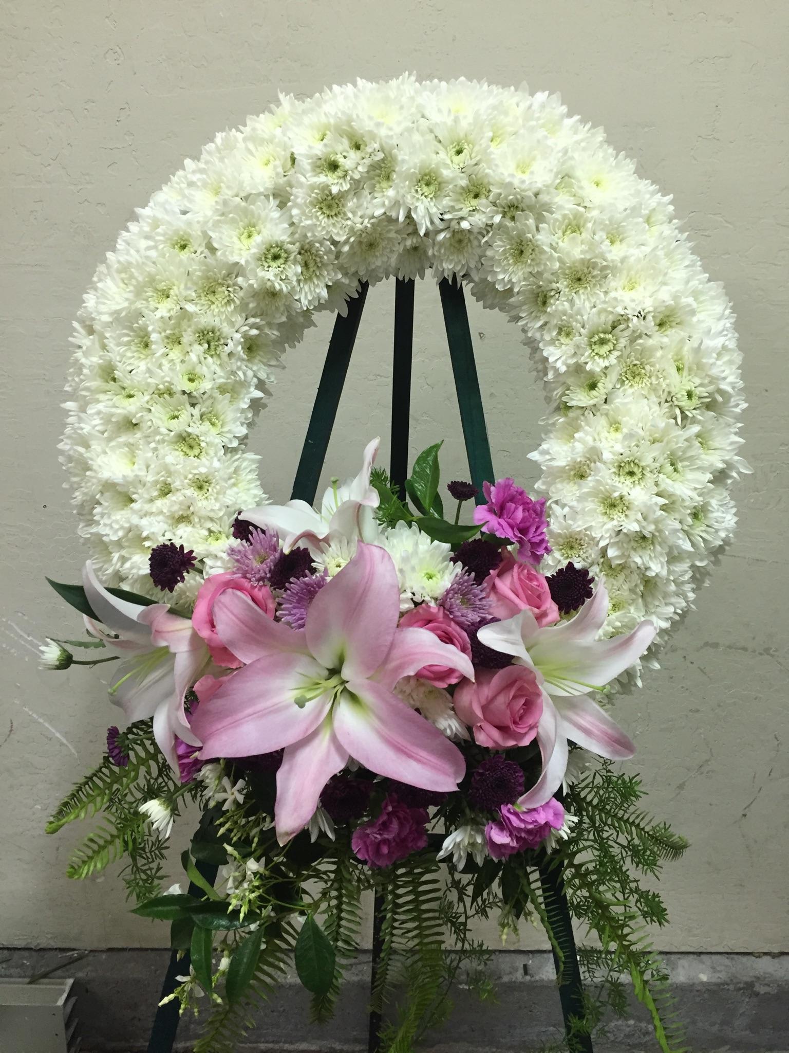 Wreath 1 - wreath spray of lilies, roses, daisies and greens.