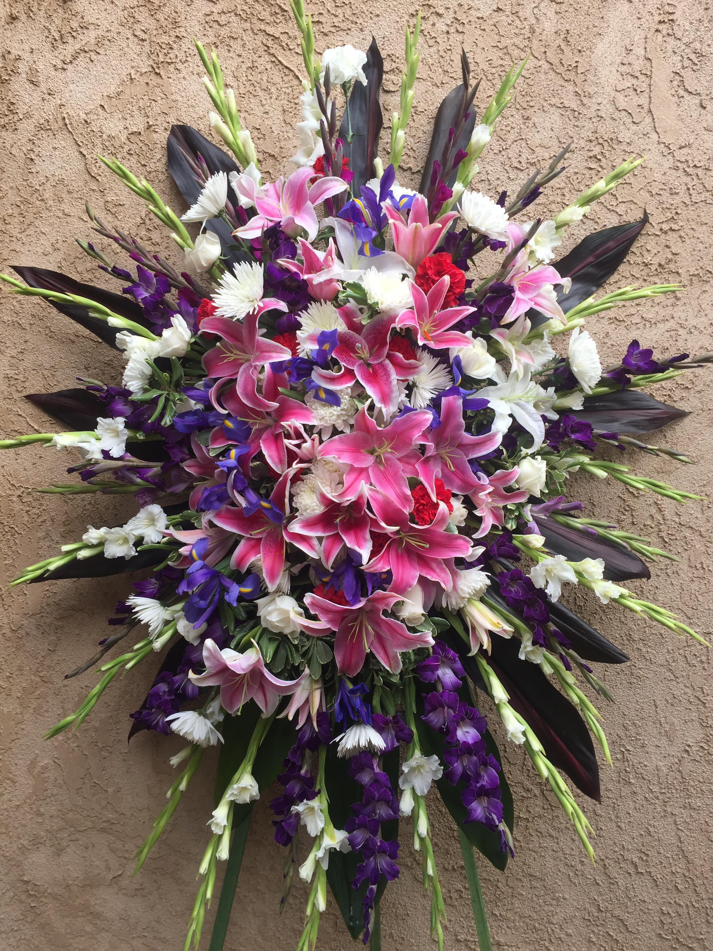 Funeral Spray 13 - standing spray with pink, white and purple flowers.