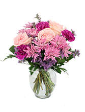 'Yours Truly" 'Yours Truly" - Pretty mixture of pale pink roses, lavender mums and fushia colored carnations designed in a low pava style garden vase.