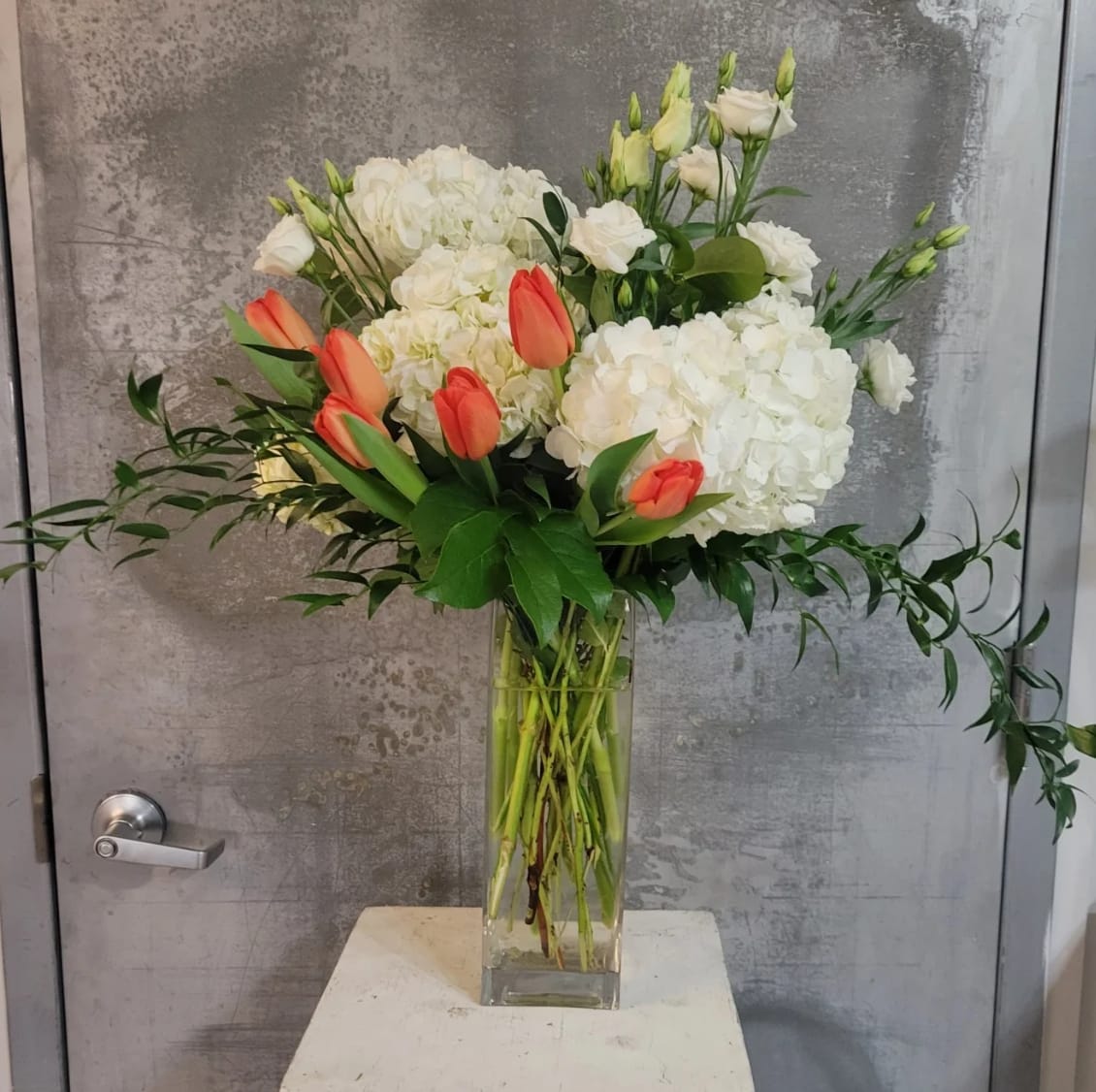 Creamsicle Delight Creamsicle Delight - This Beautiful spring inspired arrangement is made in a 4" by 14" Rectangular Vase and is around 26" overall in height. Perfect for any occasion.