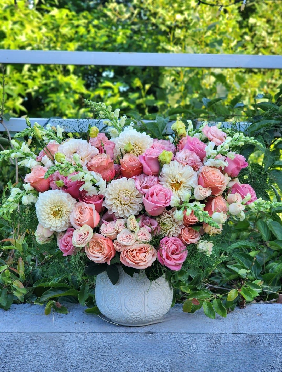 Birthday Flowers  - This stunning floral arrangement in a ceramic vase features  of peach, pink roses, accented by pink dahlias, while lush fern greenery completes the luxurious design. Perfect for upscale events and special occasions.  