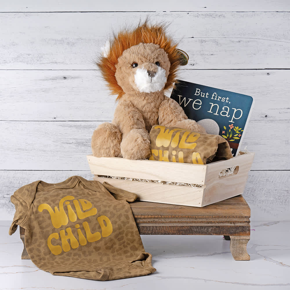 Wild Child Baby Crate Wild Child Baby Crate - Welcome the newest little adventurer with our Wild Child Baby Gift Basket. This delightful collection includes an adorable plush lion, ready to become the perfect cuddle companion for your wild child. The cozy onesie, featuring the playful message "Wild Child," adds a touch of fun to their wardrobe. To complete the set, we've included the charming book "But First, We Nap," ideal for soothing storytimes. Thoughtfully curated, this gift basket is the perfect way to celebrate and embrace the joyous spirit of their new arrival. Contents: Plush Lion, "Wild Child" Onesie, 'But First, We Nap' Book