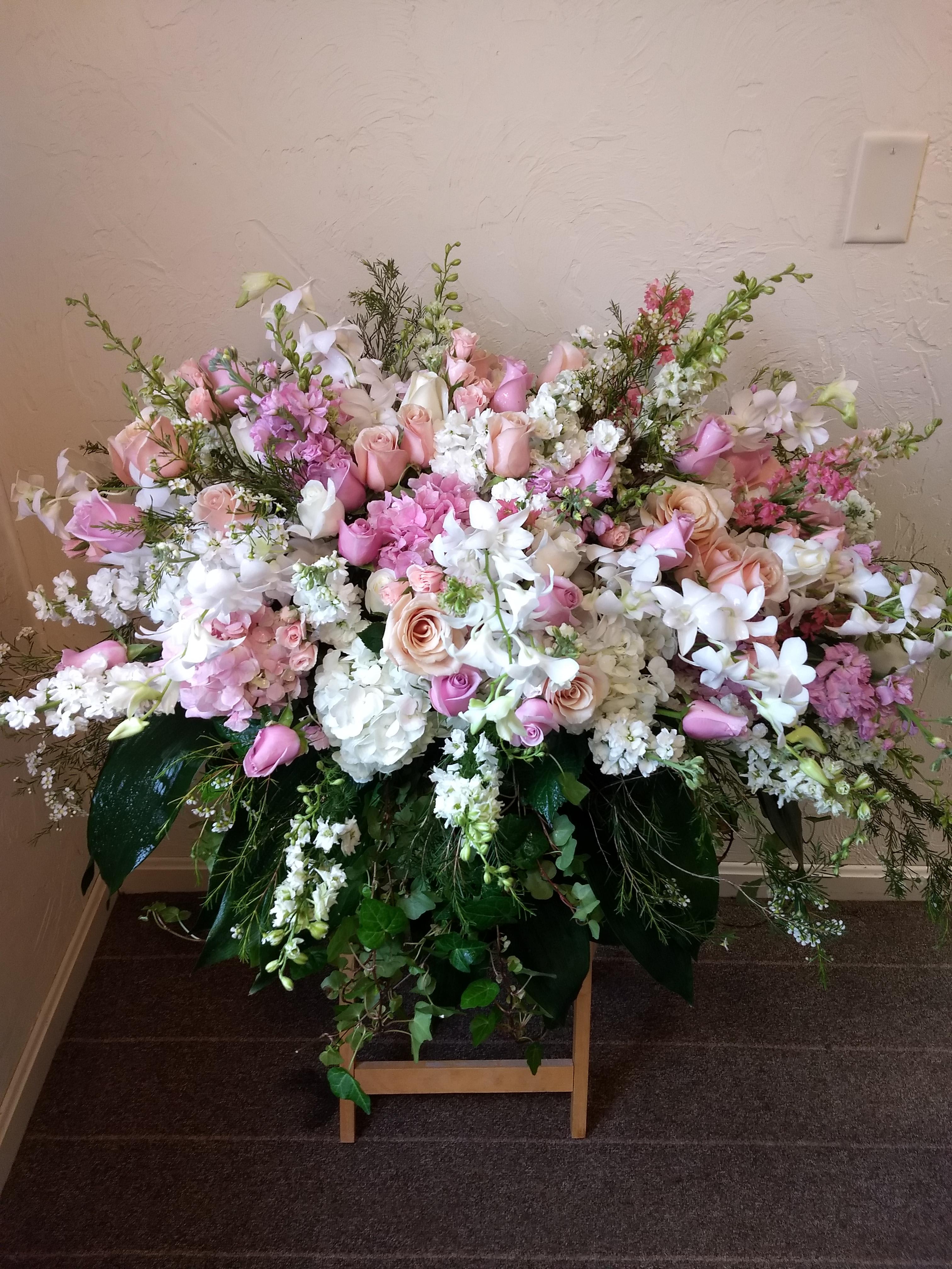 Always Adored Casket Spray #T236-3A - A beautiful spray of soft pink, white and crÃ¨me blooms ease the burden of loss.  **** Please note: 48 hour notice MAYBE REQUIRED We custom-design this arrangement using best-of-day seasonal flowers. This image is a general representation of its size and style and may not feature the exact flowers shown. Due to disruptions in the global supply chain and staff shortages, we may have to make last minute substitutions to your selected design. If we need to make significant changes we will call you first to get your approval*** Thank you for understanding.