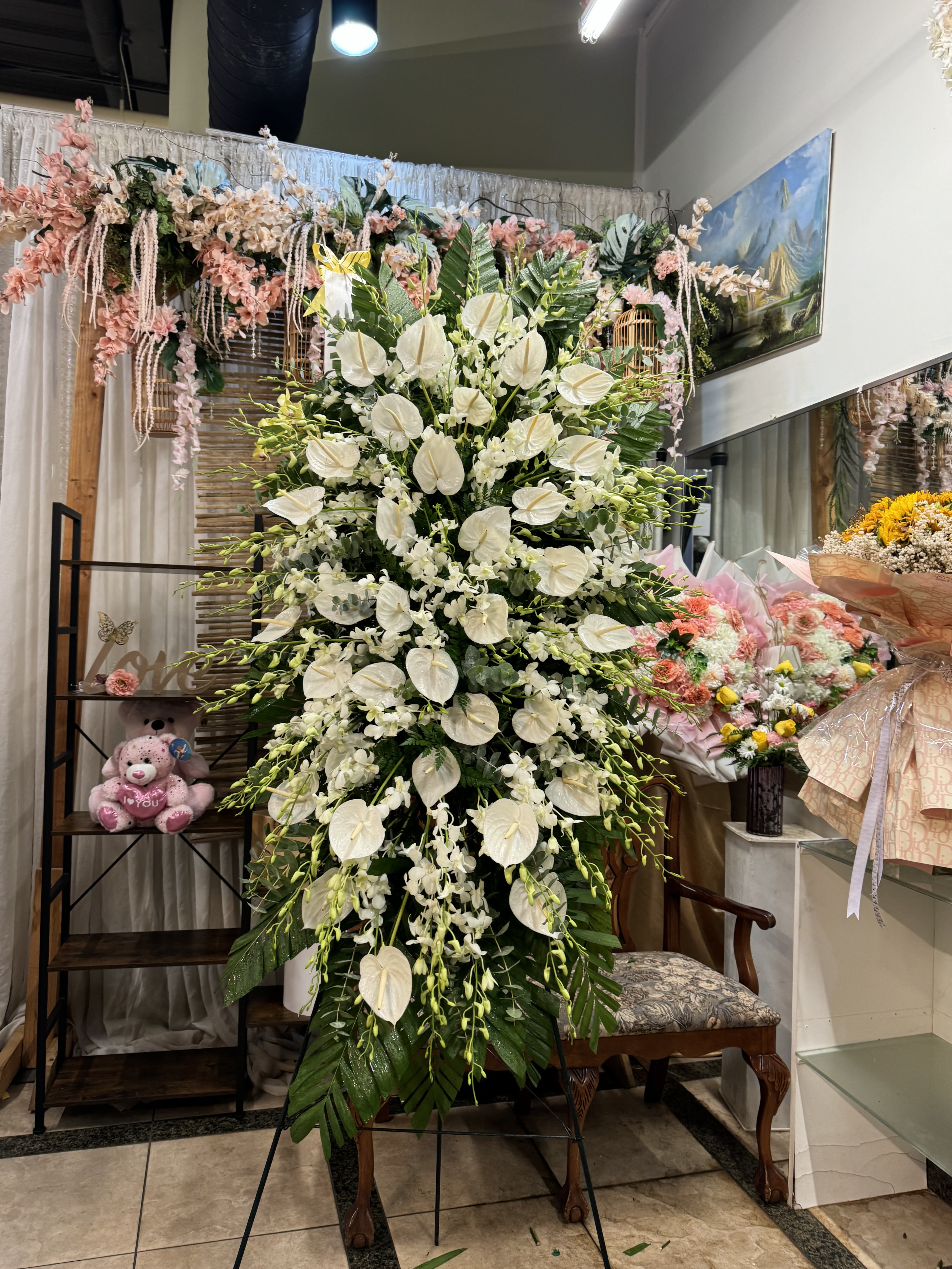 Tropical Bliss Tropical Bliss - A standings flower arrangement for a funeral service is a heartfelt tribute designed to honor and celebrate the life of the deceased. These arrangements are typically displayed on an easel or stand, making them highly visible and a central part of the memorial decor.