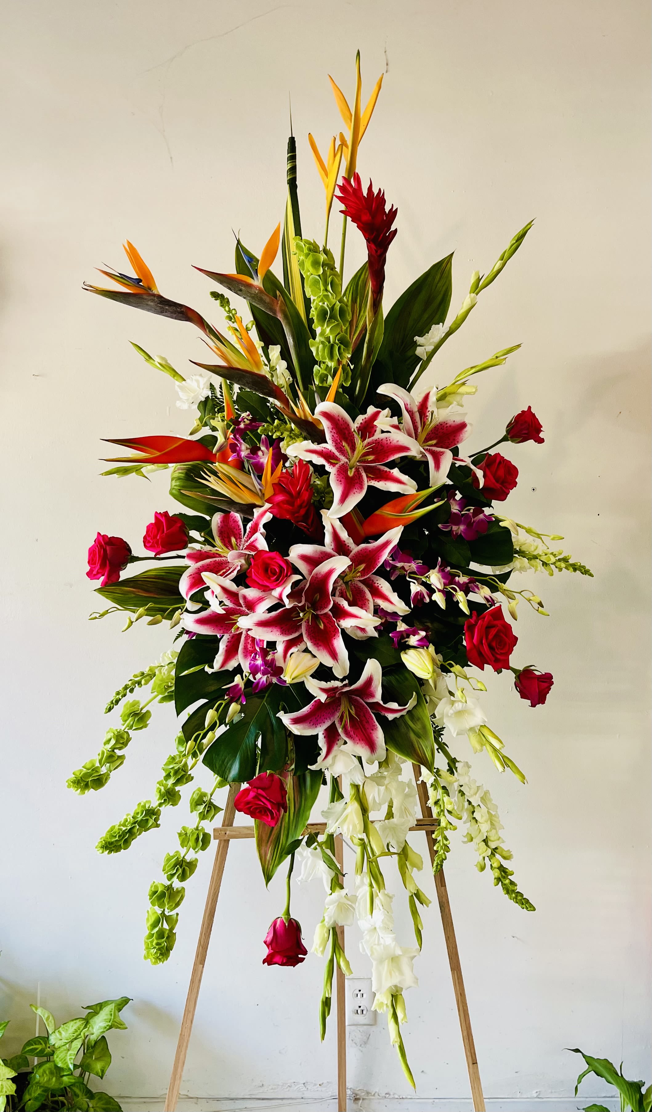 Peaceful Paradise Peaceful Paradise - An elegant arrangement of tropical flowers and greenery, lilies and roses. A perfect way to brighten up a celebration of life.